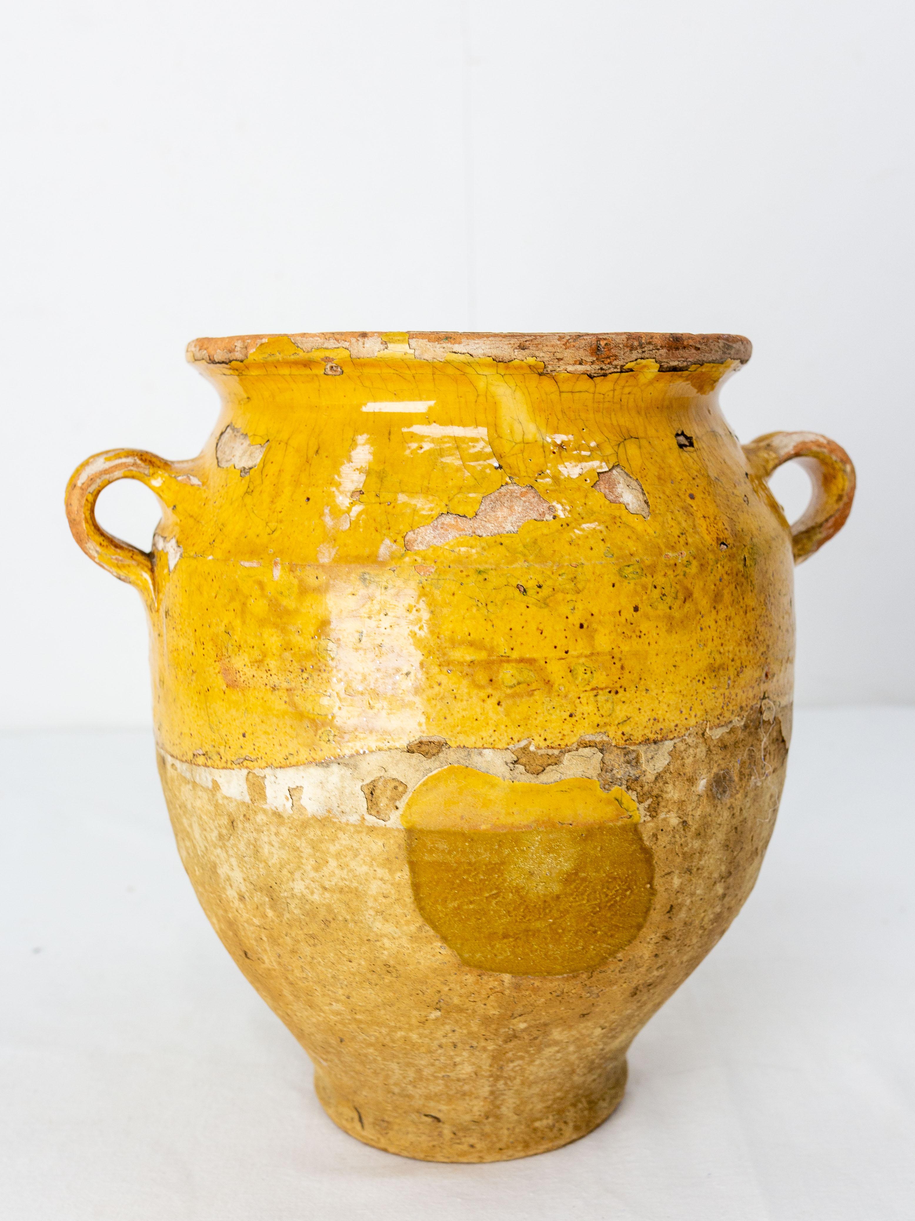 French terracotta confit pot.
Traditional large earthenware pottery confit pot from South West France with yellow glaze.
This vessel was used from the 19th to the mid-20th century to conserve food.
Very decorative.
Good patina and bright yellow