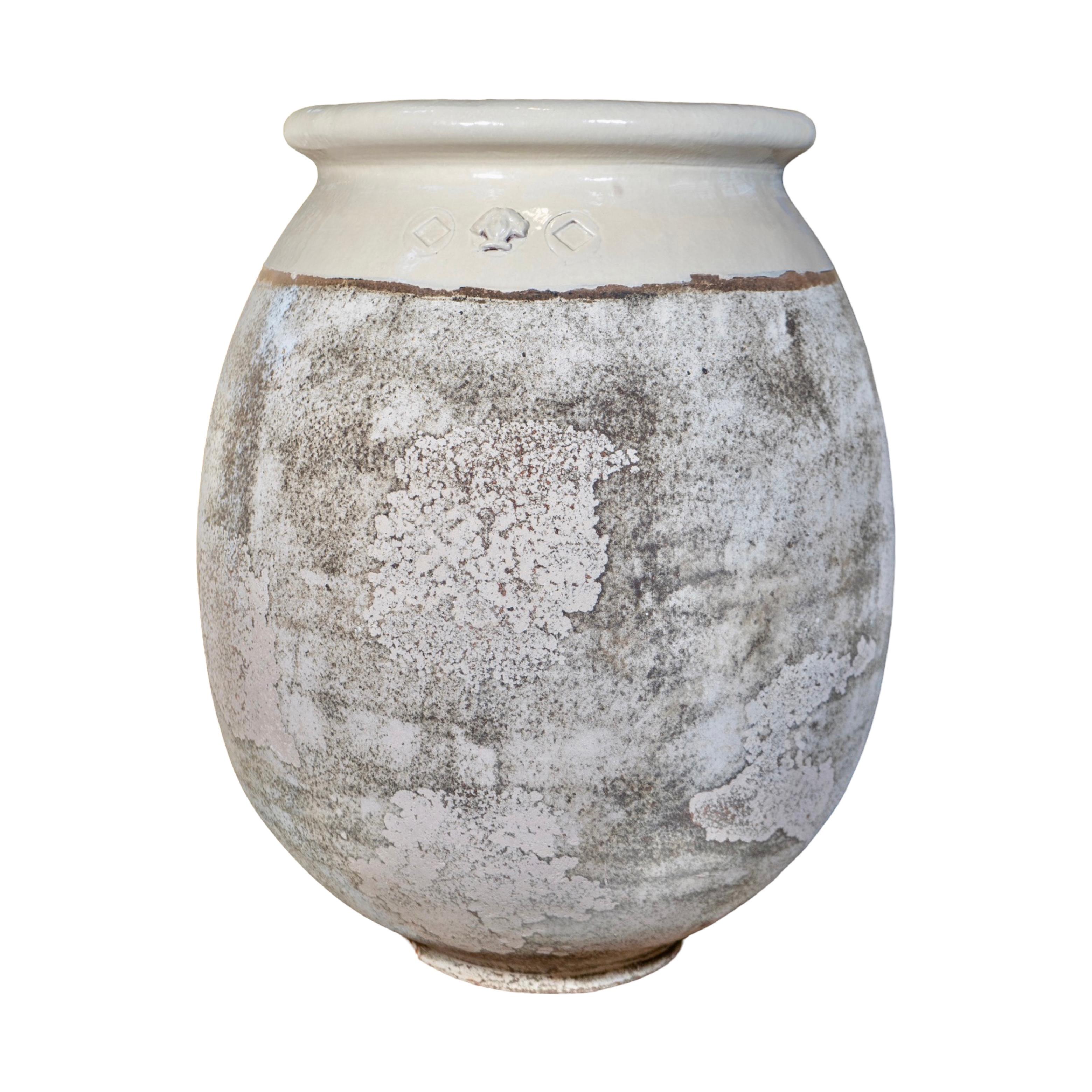 This French Terracotta Glazed Planter is a contemporary piece, handmade in France, with a glazed beige finish and a textured surface for a beautifully aged look. Crafted from genuine terracotta, it features a carved medusa motif in the center for an