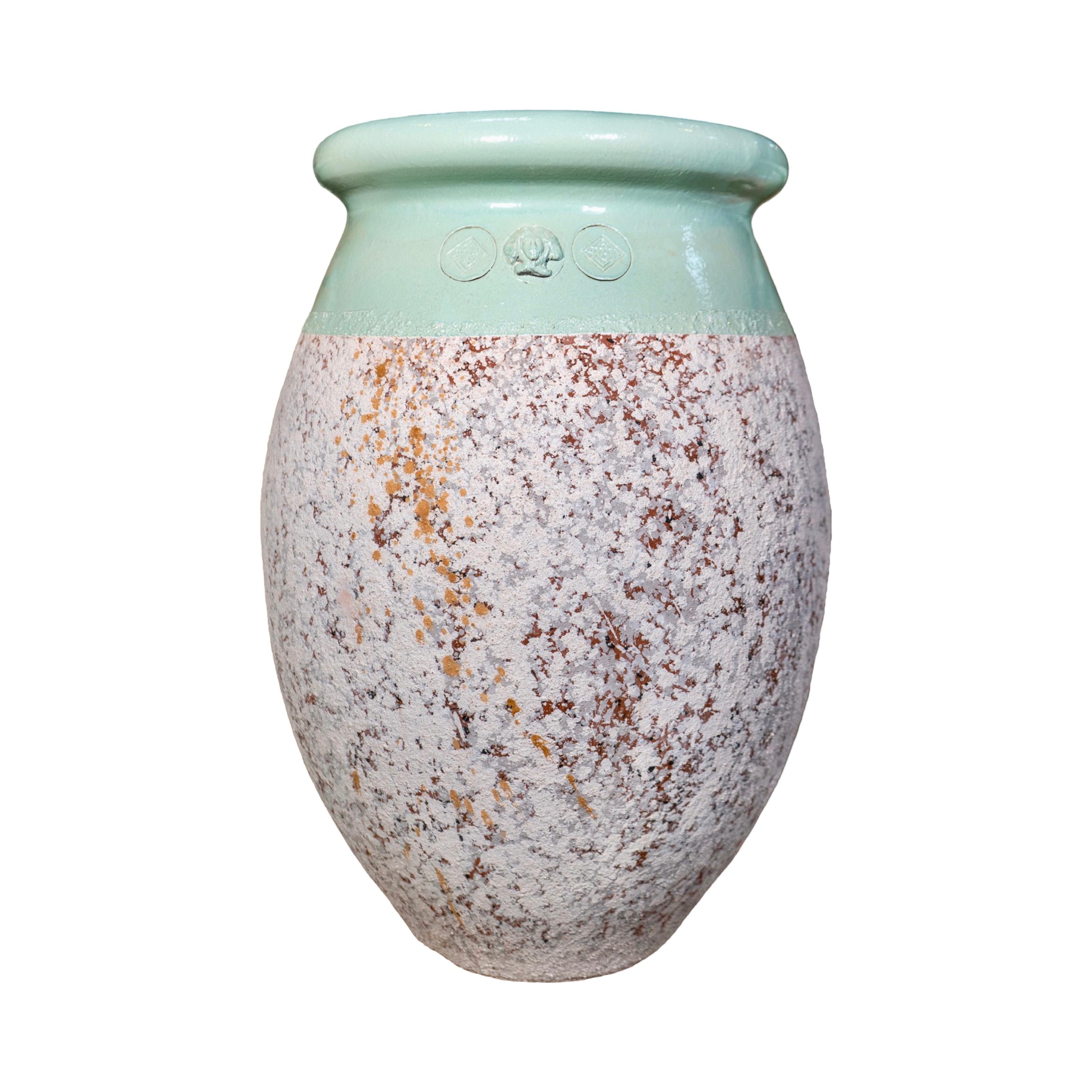Handmade in France, this olive jar blends contemporary craftsmanship with old-world character. Each piece is shaped by hand, guided by the potter’s inspiration, and finished with a verdigris enamel collar and soft firing patina that give it a