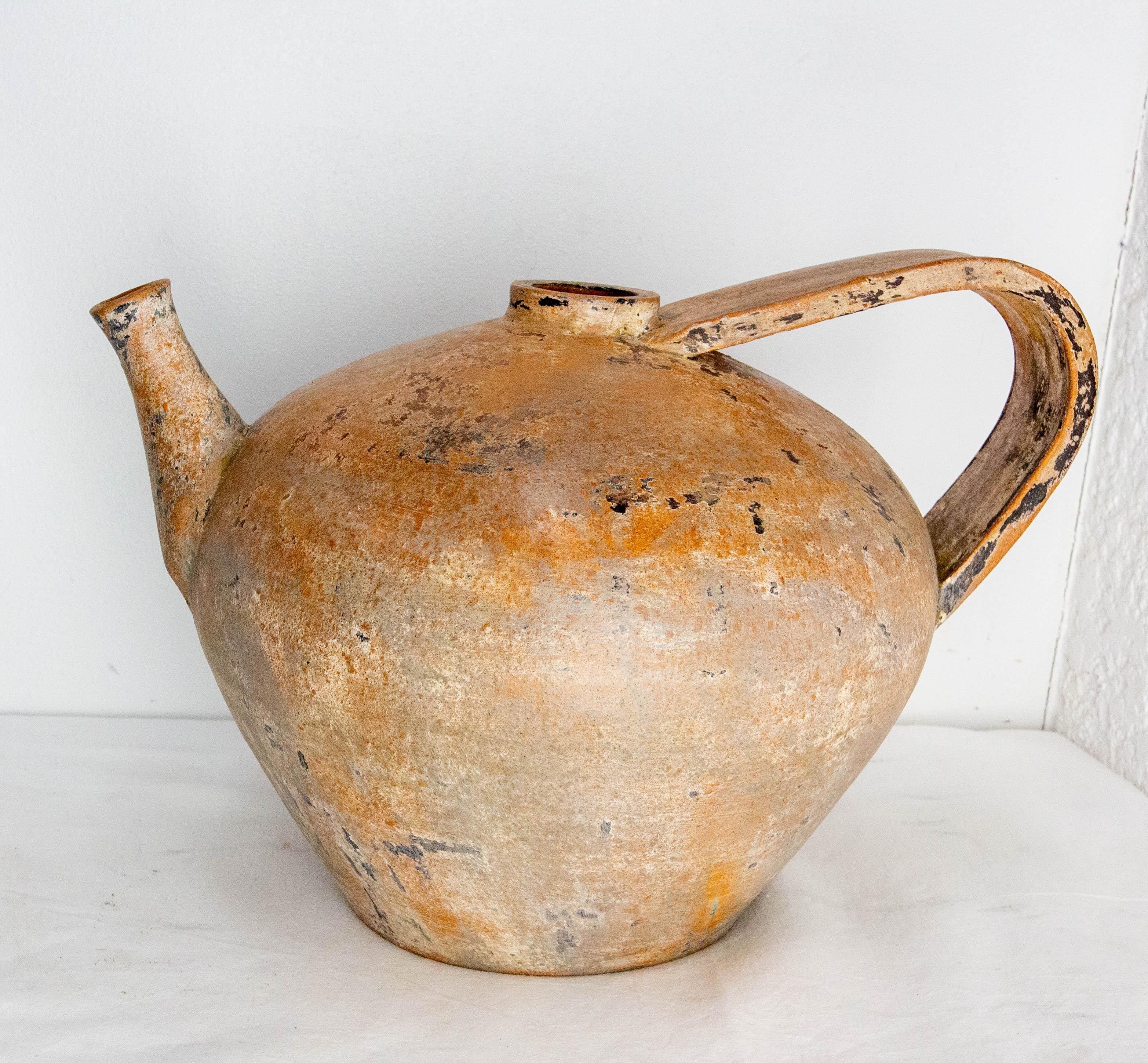 Vintage terracotta jug French pitcher
This terracotta pitcher was painted and lated patinated, circa 1970.
Good and heavy.
In the 19th century, this pitcher was used to keep the well water cool. 

Very good condition .
Shipping: 36 / 45 / 41 cm
 