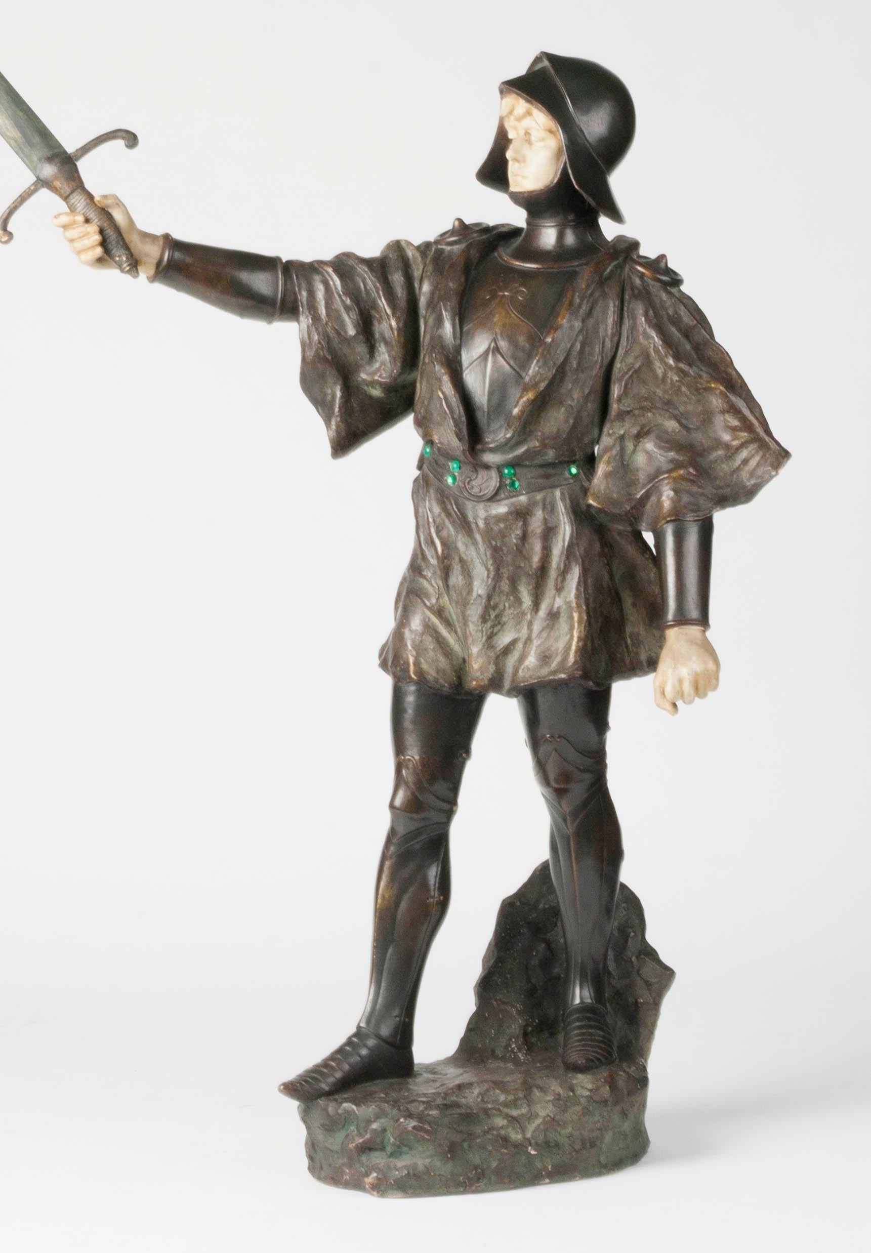 Beautiful terracotta statue of a knight with a sword. The image is signed J. Dupré. The image also has a blind mark that says 'Reproduction Reservée', which can be translated as 'All rights reserved'. The image has a beautiful, powerful appearance.