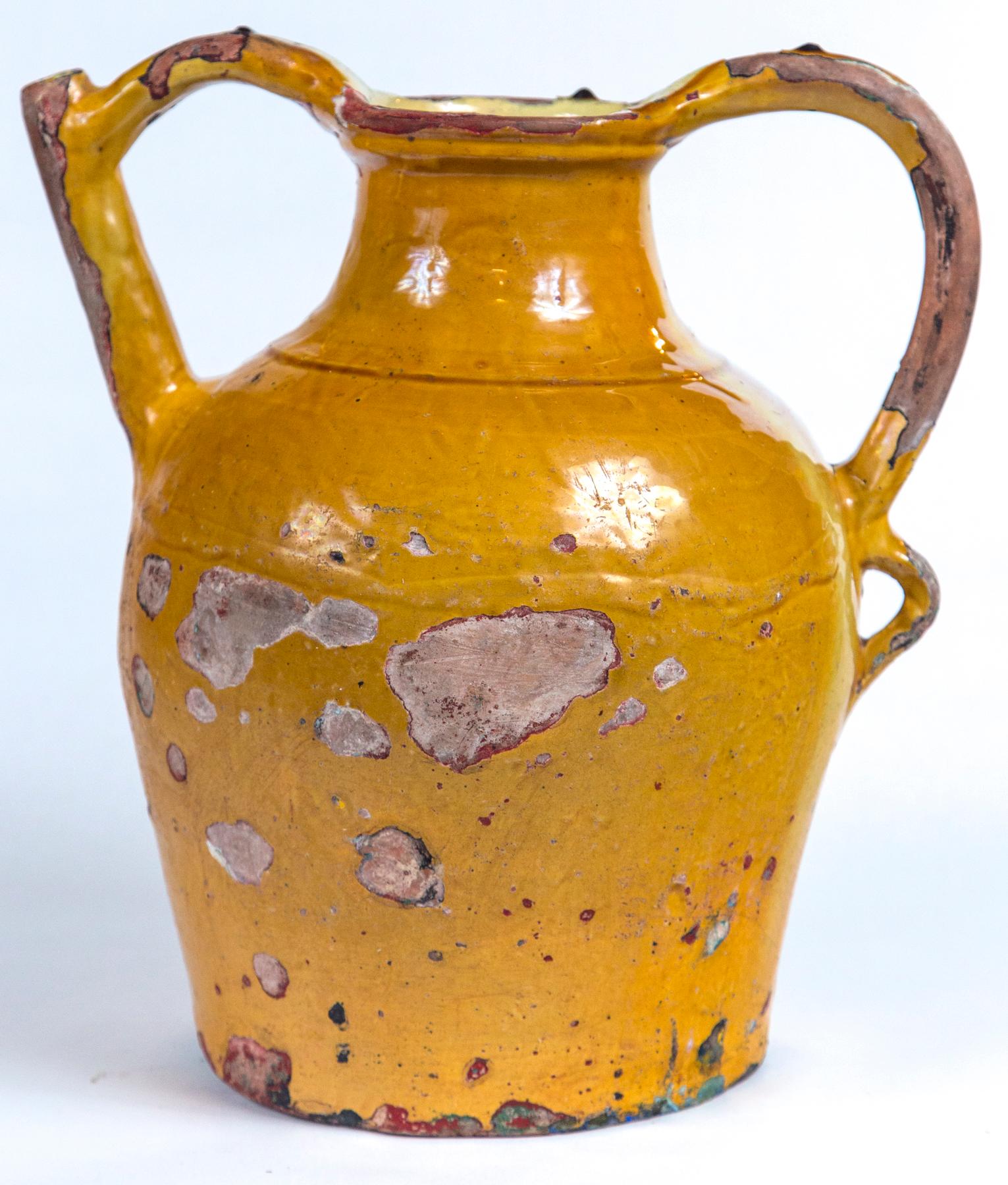 French terracotta water pitcher (Gargoulette), 19th century. A wonderful and rare piece of pottery. The double handled design was for serving water at the table. Traditional mustard yellow glaze on the exterior, paler yellow glaze on the interior.