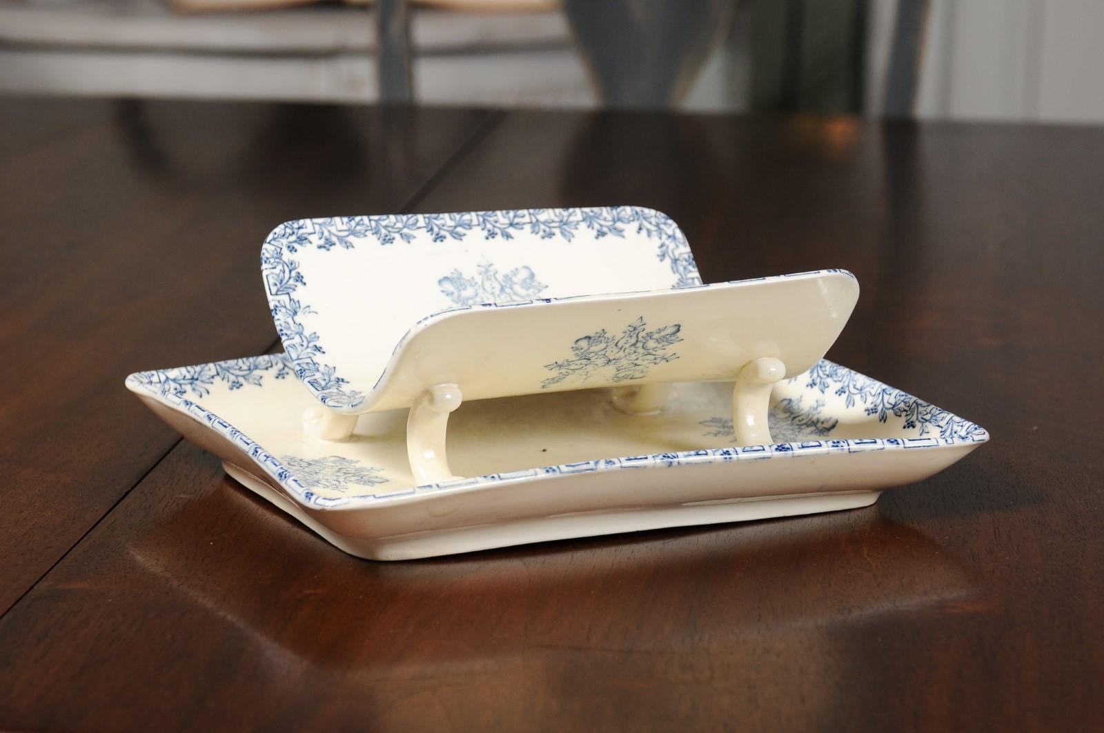 A French Terre de Fer blue and white asparagus platter from the 19th century, with strainer. Born in France during the 19th century, this Terre de Fer platter features a curving asparagus cradle raised on petite feet and adorned with a blue foliage