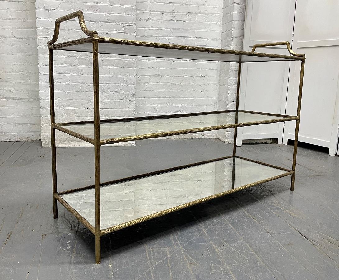 French, three-tier bar cart style of Maison Baguès. The frame of the cart is metal with a bronze finish with three original mirrored tops.