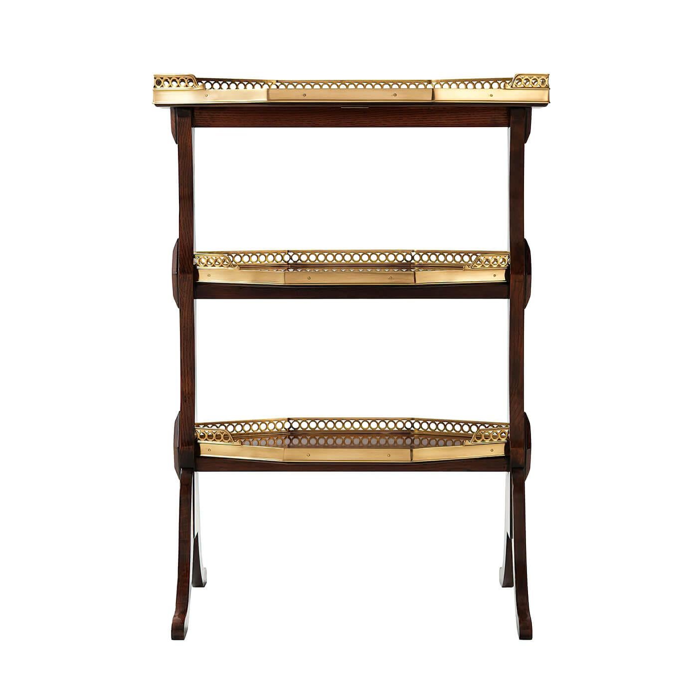 A French Directoire style three-tier lamp table, each elongated octagonal tier with a three-quarter pierced brass gallery, on shaped end supports with lozenge ornaments, terminating in splayed feet.

Dimensions: 20.5