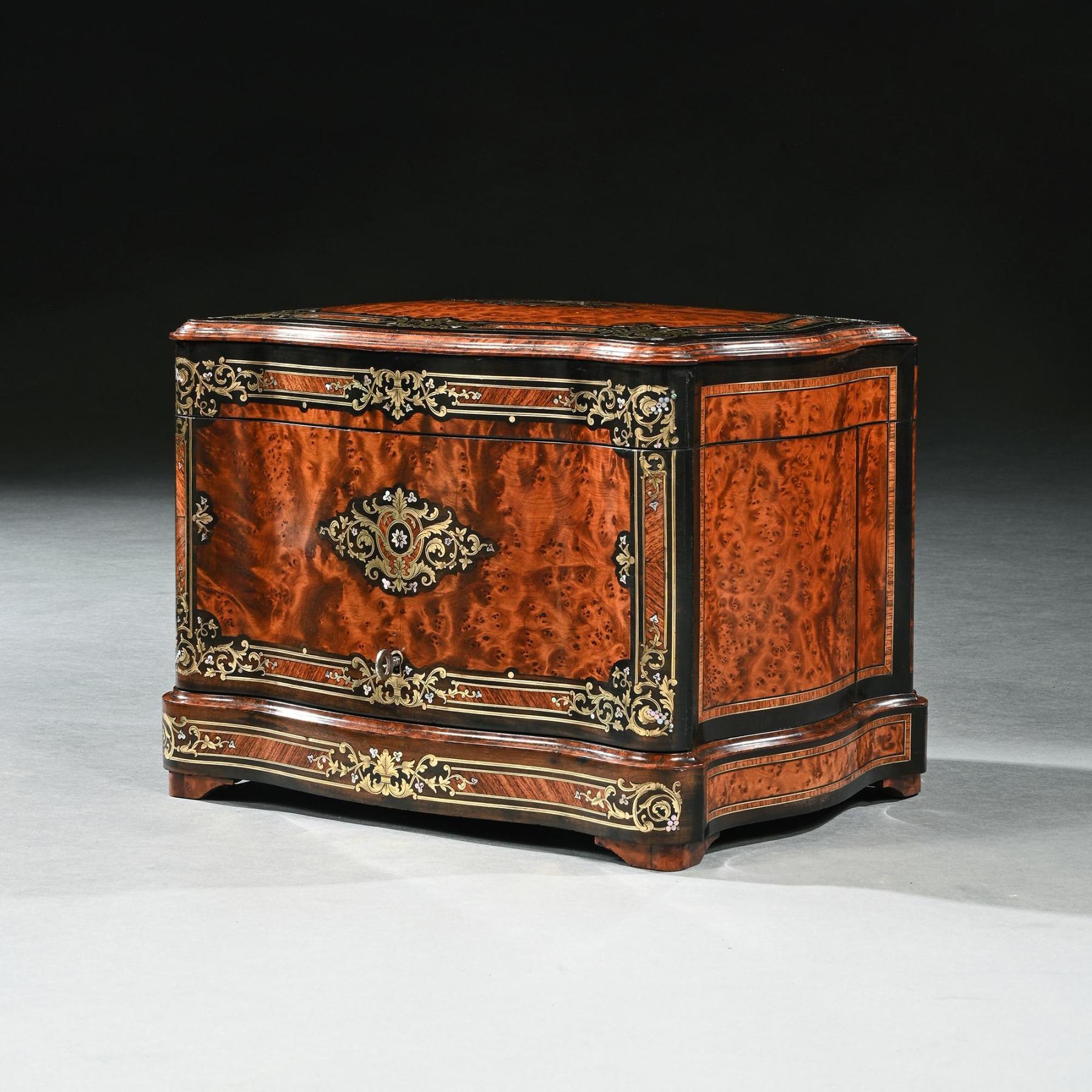 An Exceptionally Fine French Serpentine and brass marquetry inlaid Cave a Liqueur or Tantalus Box with mother of pearl.

French circa 1870
 
 Primarily veneered in fine thuya wood of wonderful colour and figure, the serpentine form of this box is