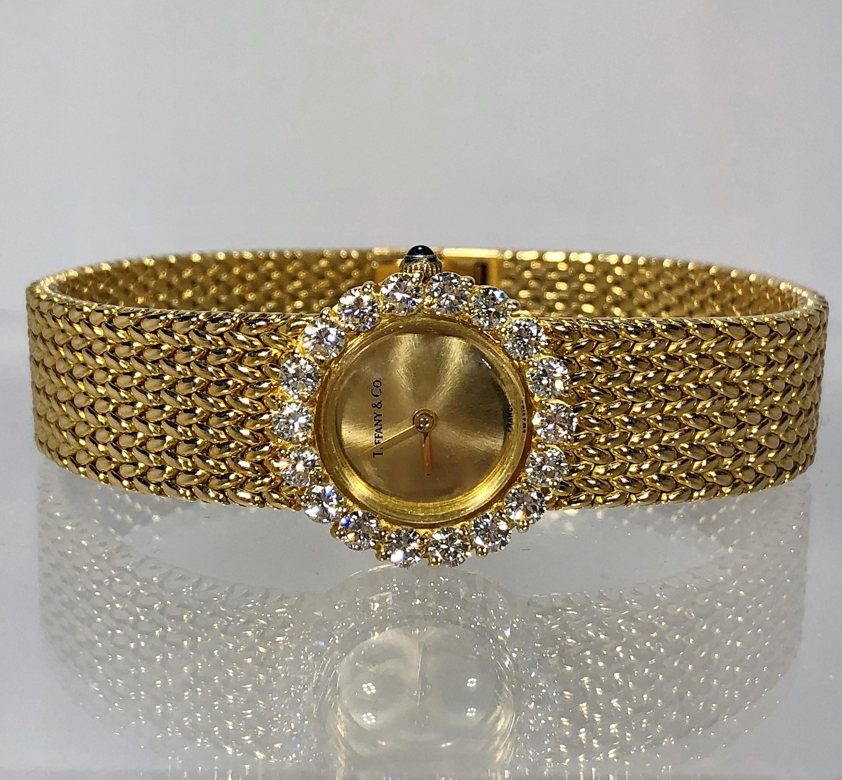 Made in France, this elegant 18K yellow gold wristwatch has a
round head surrounded by a diamond bezel set with 18 brilliant 
cut diamonds weighing an approximate 2.15CT total of F Color 
and VS1 Clarity. Measuring 7 inches in length by 13/16 inch