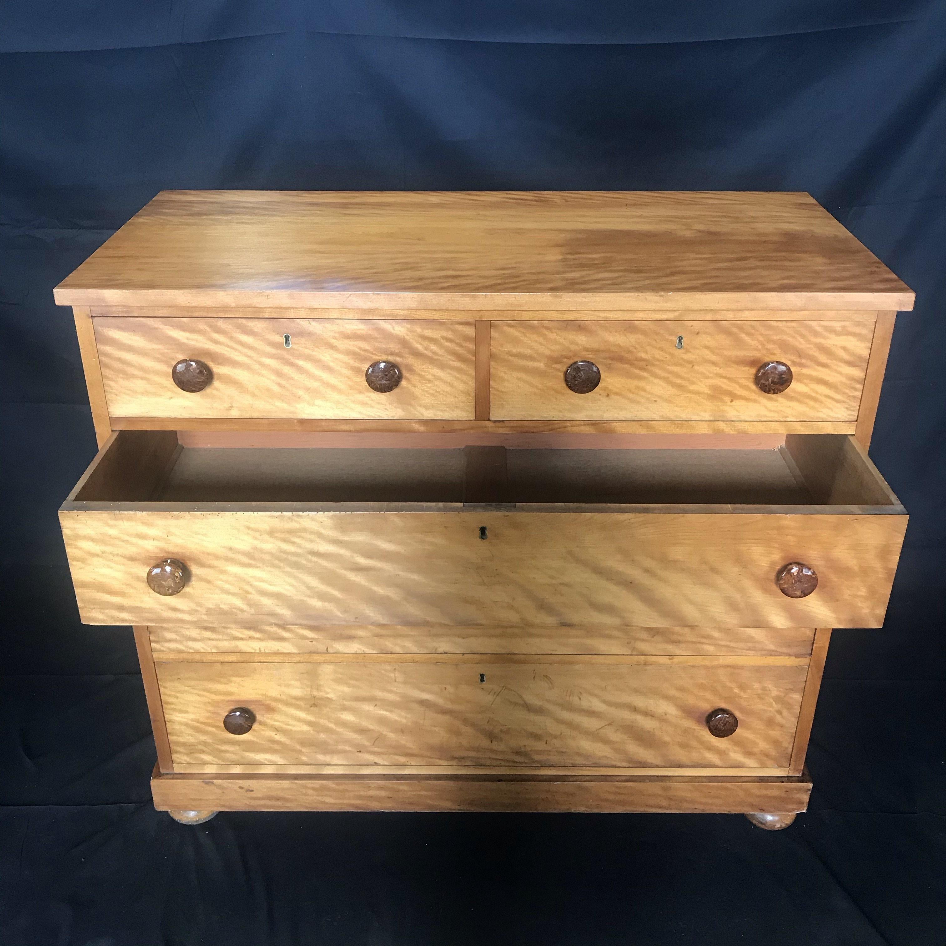 Beautifully crafted French tiger's eye maple wooden dresser having gorgeous grain and handsome porcelain drawer pulls. There are two smaller drawers on top of 3 roomy ones, all smoothly functional. Wood is almost iridescent - gorgeous!
#3569.
