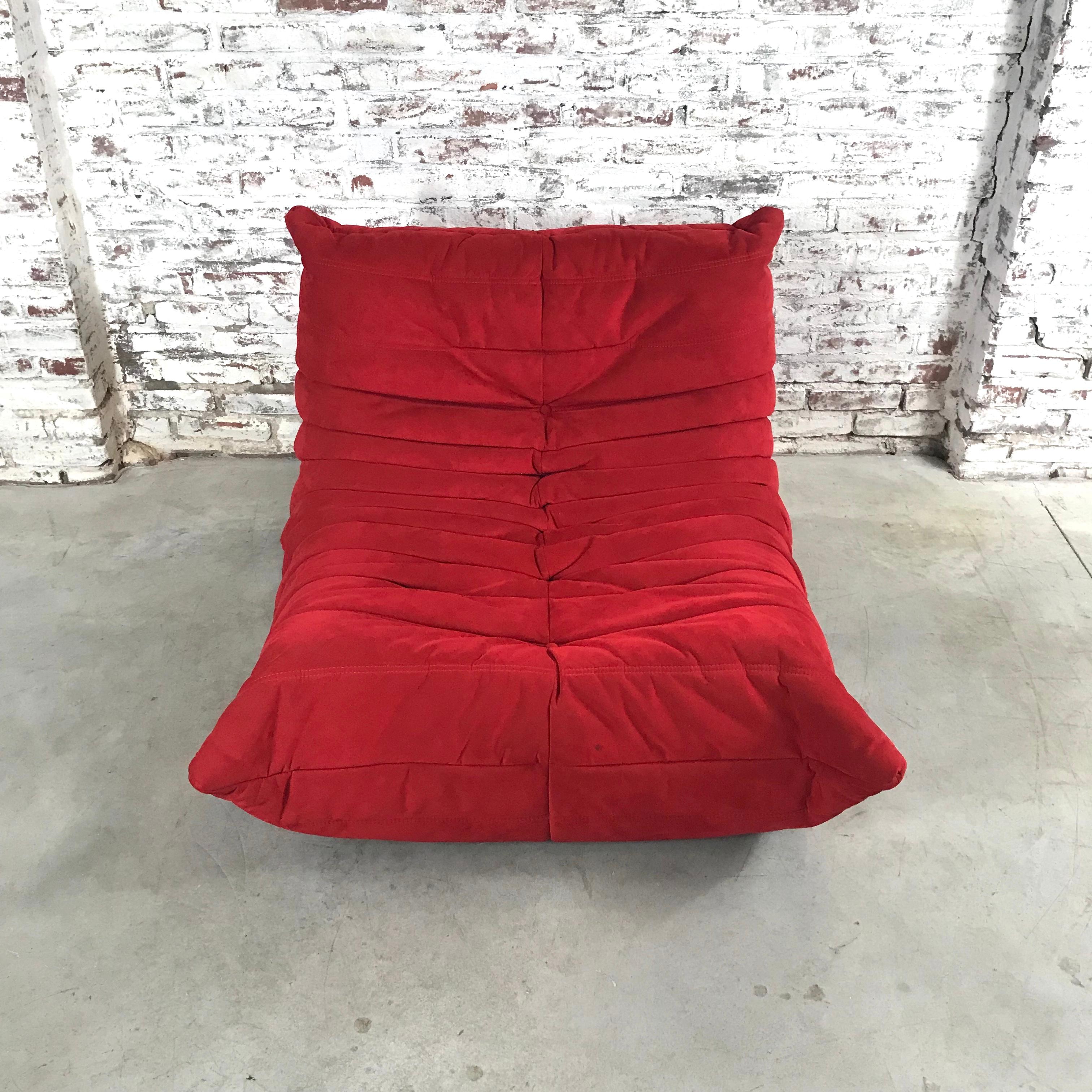 The Togo was designed by Michel Ducaroy in 1973 for Ligne Roset. This original Togo lounge chair or “fireside chair is upholstered with Alcantara in the color Goya red.