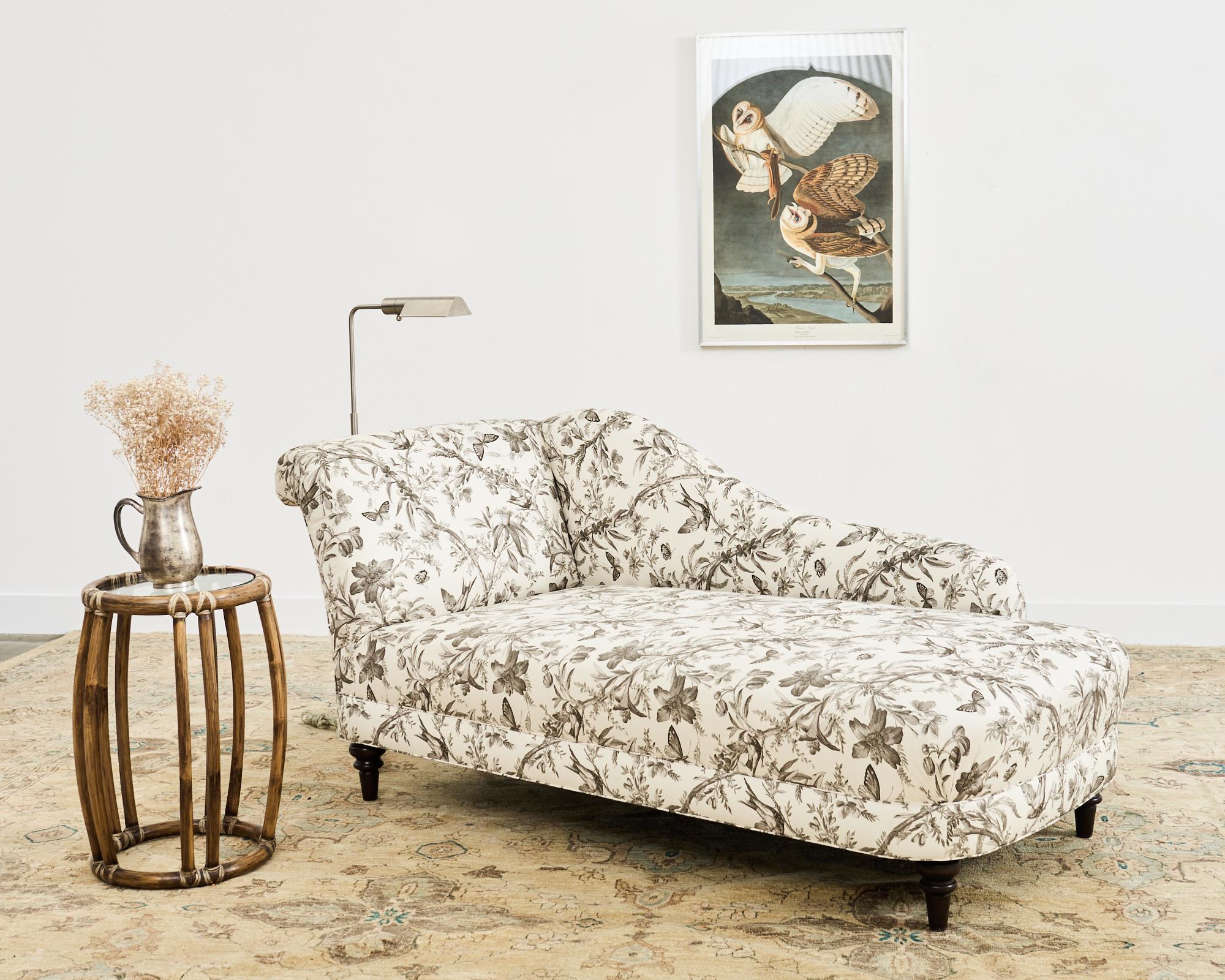 Dramatic bespoke daybed, chaise lounge, or recamier featuring a French Toile de Jouy upholstery with delicate flora and fauna motifs. The large hardwood frame has a stunning fabric with birds and flowers over an off-white ground. The lounge is