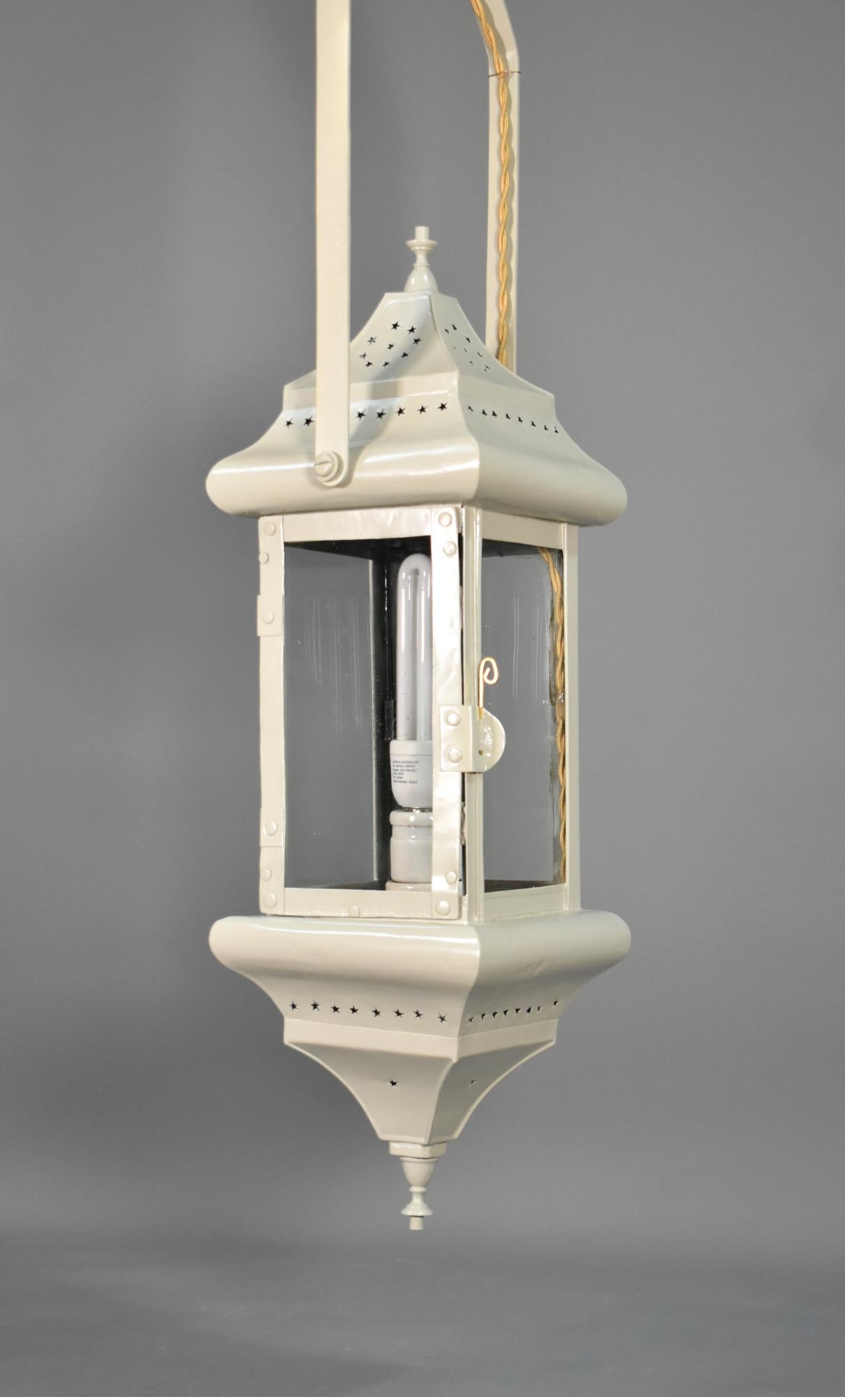 French Tole Hall Lantern

An elegant French Interior Hall Lantern featuring an appealing light grey paint finish with matching finials with pierced toleware metalwork at the top and base.

The hinged door with a brass pin holder gives easy access to