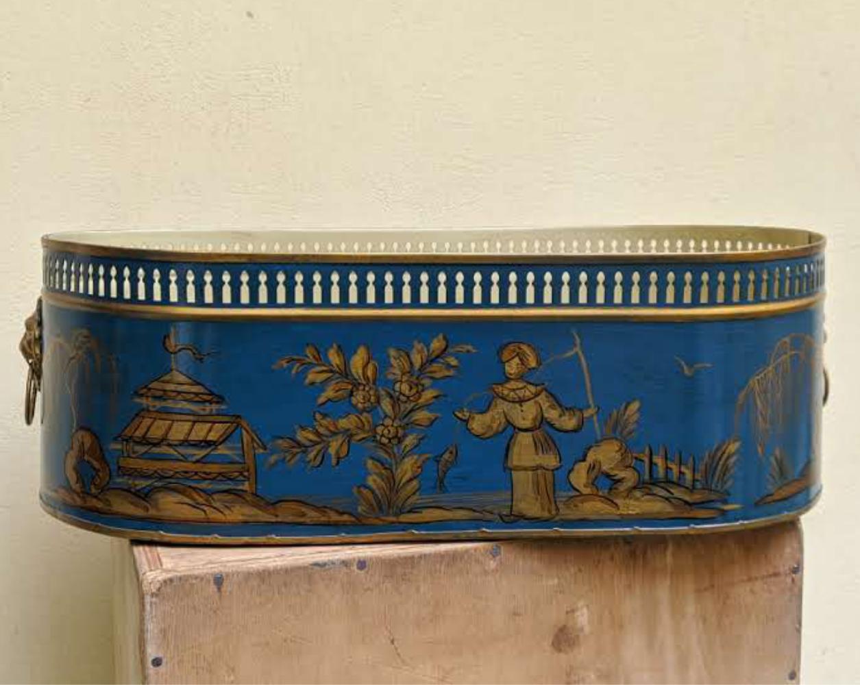 Limited production of French tole cachepot in chinoiserie style. Hand painted, Available in different colors. Two versions: one with a Chinese scene, the other with a vegetal decoration motif, typical of the Louis XVI period. Oval shaped with lion