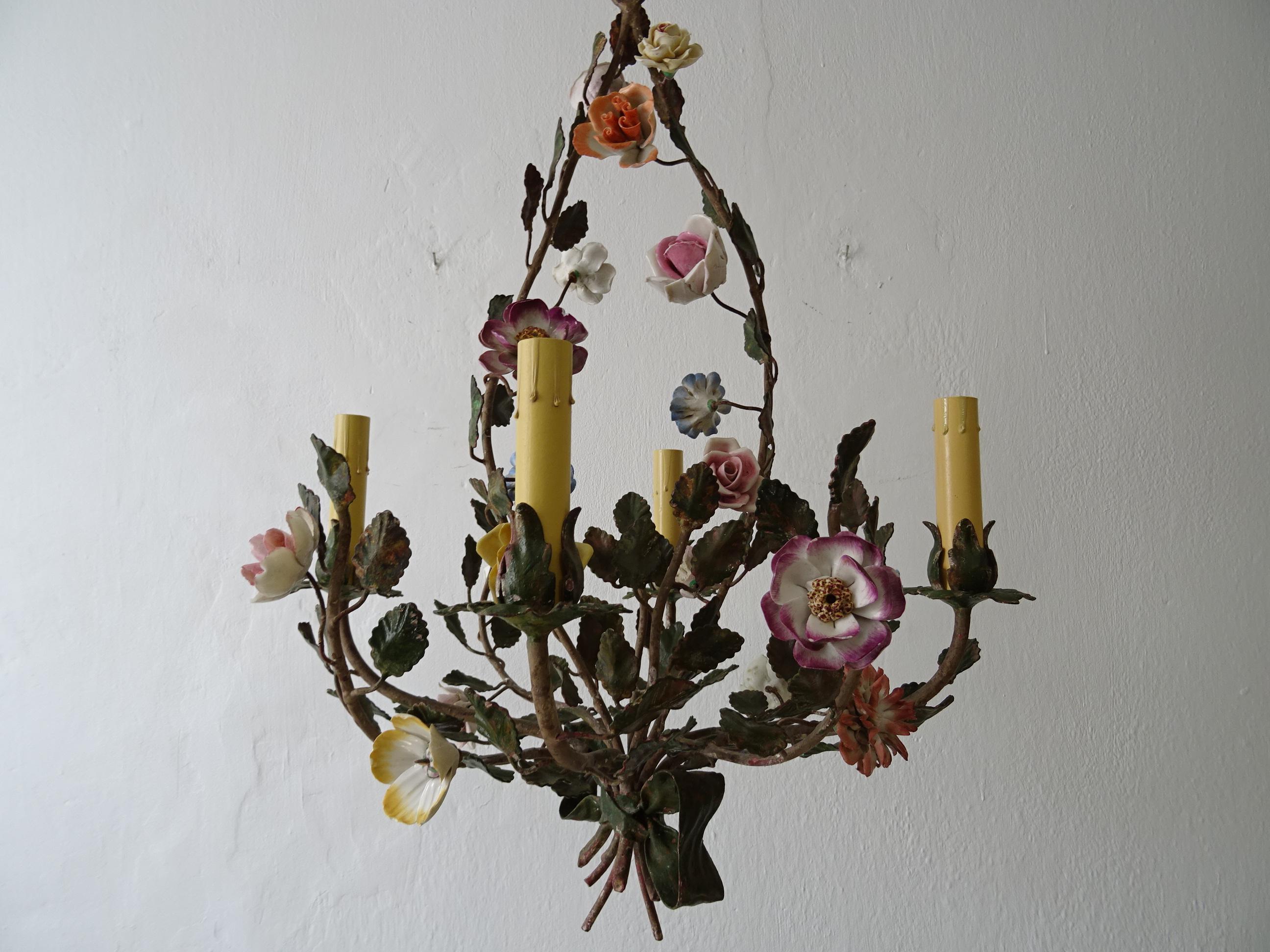 Housing 4 lights. Will be re-wired and certified UL US sockets for the USA and appropriate sockets for every other country and ready to hang! Body is heavy tole with leaves with original paint. Gorgeous handmade porcelain roses and flowers around