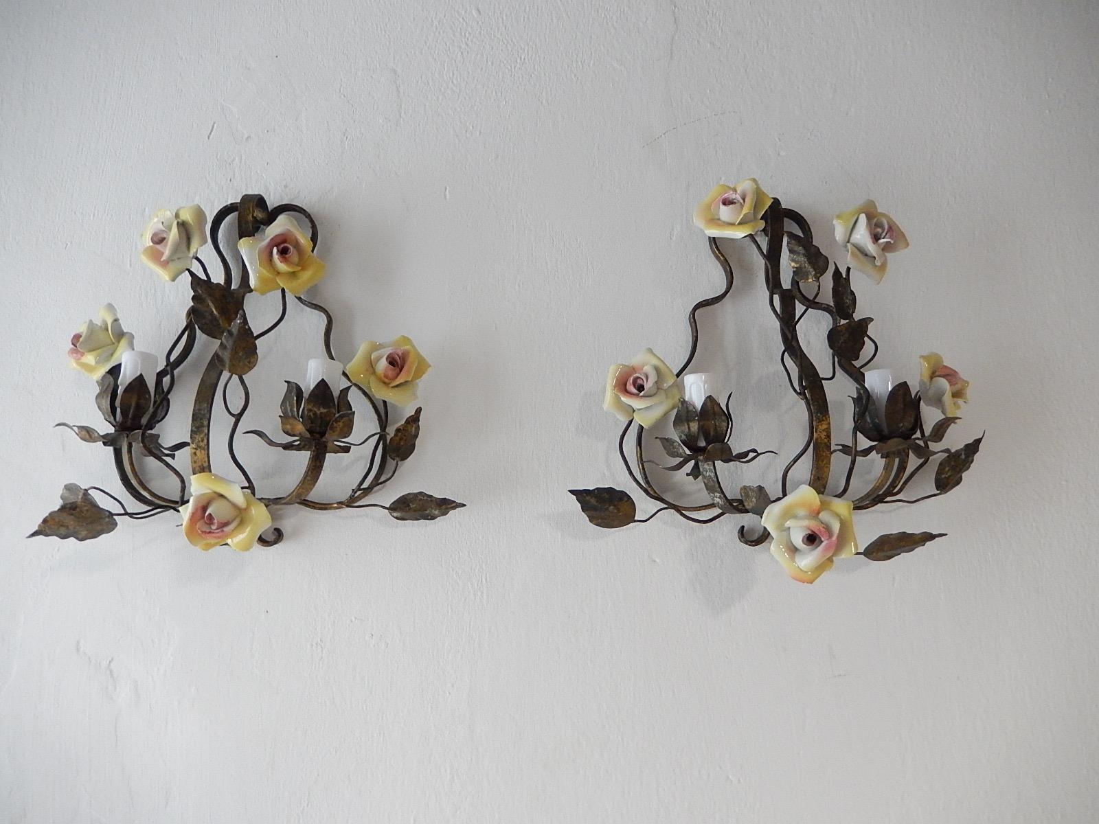 Housing two-light each. Original color tole with great patina. Adorning handmade porcelain roses in yellow with pink inside, all in great condition. Re-wired and ready to hang. Free priority UPS shipping from Italy.