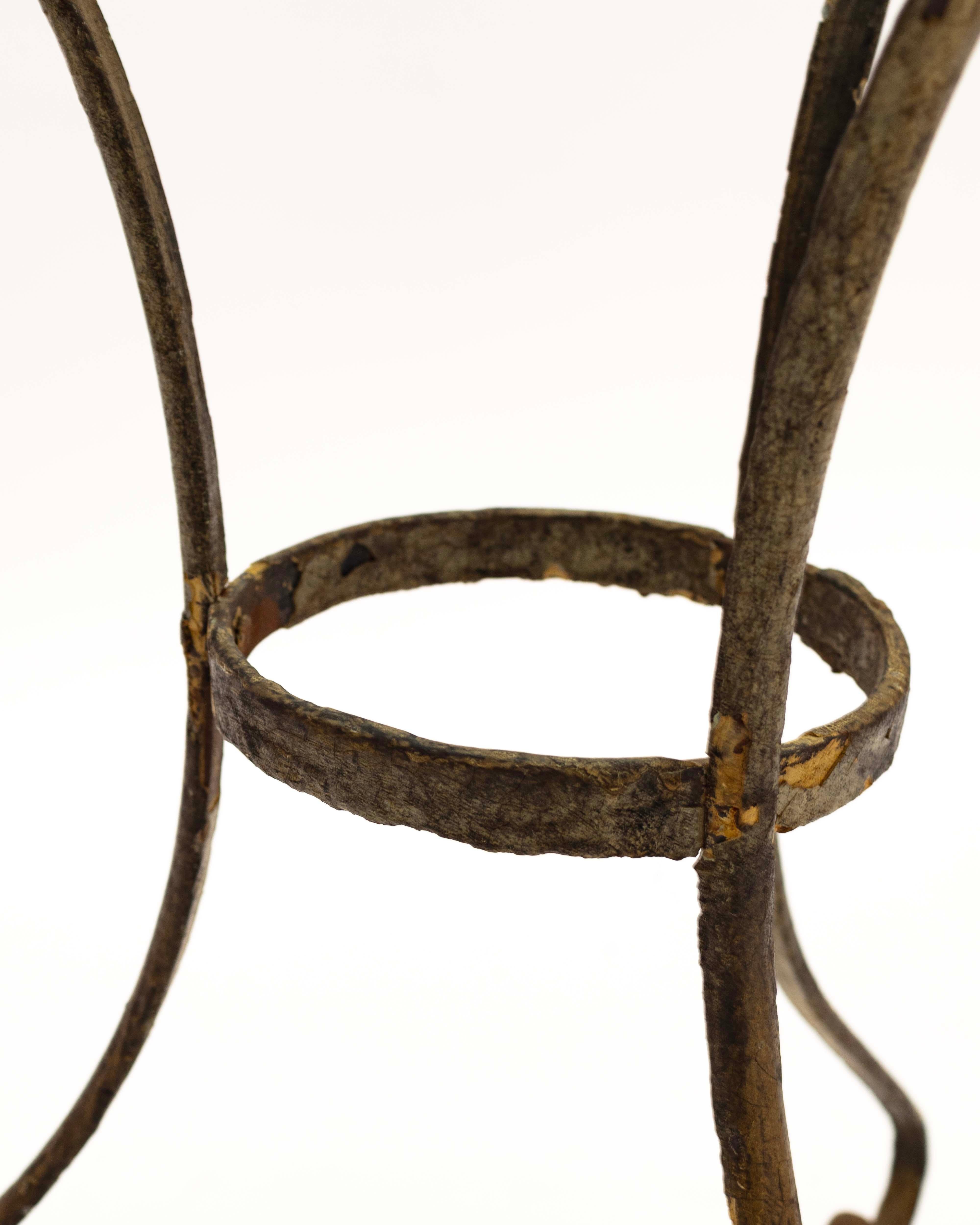 Beautiful French tole table, accompanied by a new glass table top. Tole furniture is characterized by its use of tin or thin steel, and is highlighted in the slightly weathered base of the table. This piece has acquired a warm patina over time,
