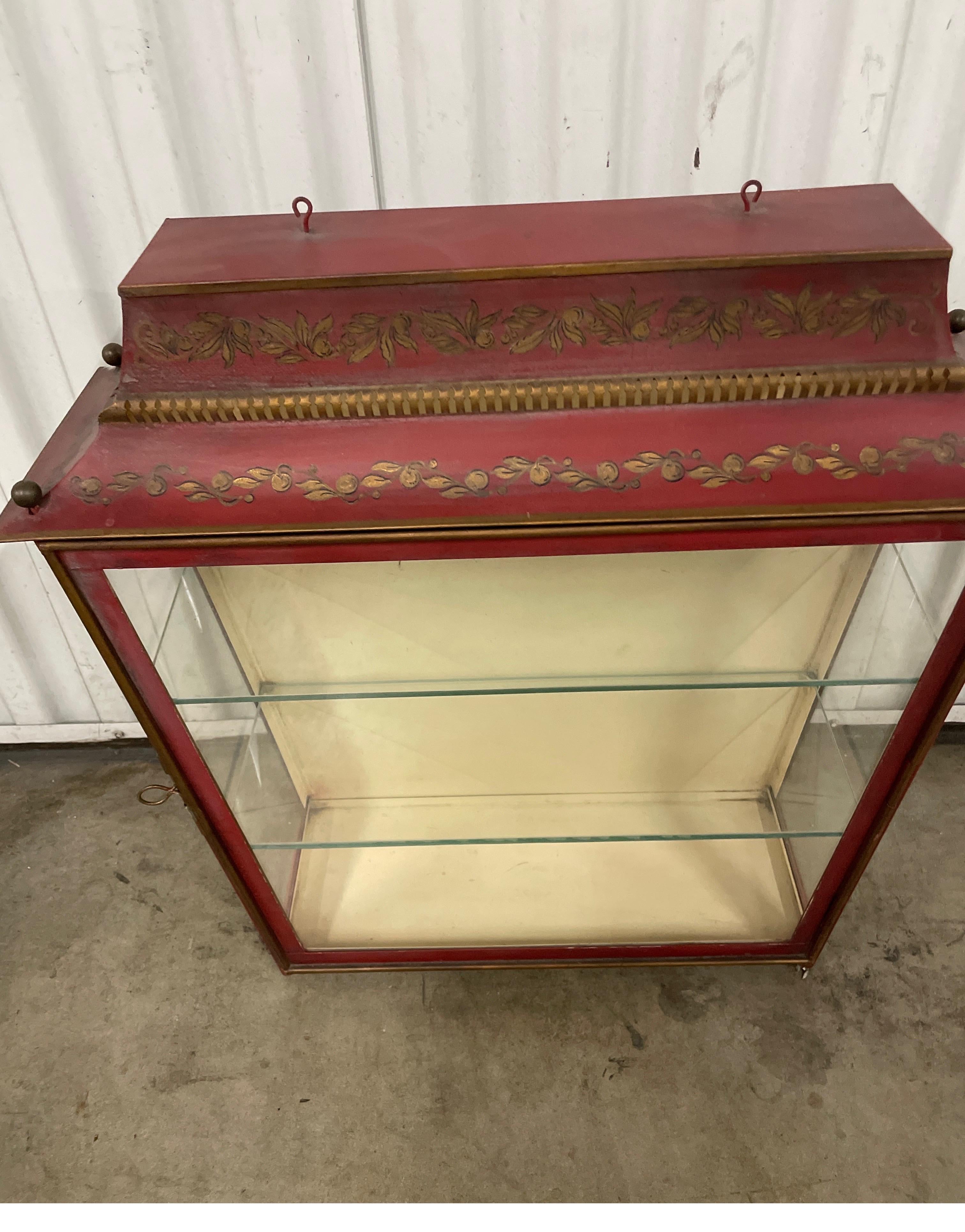 Hand painted Chinoiserie Pagoda style vitrine with two glass shelves. The front hinged door & sides are all glass. Interior light to illuminate your collectibles. A very sweet piece. 