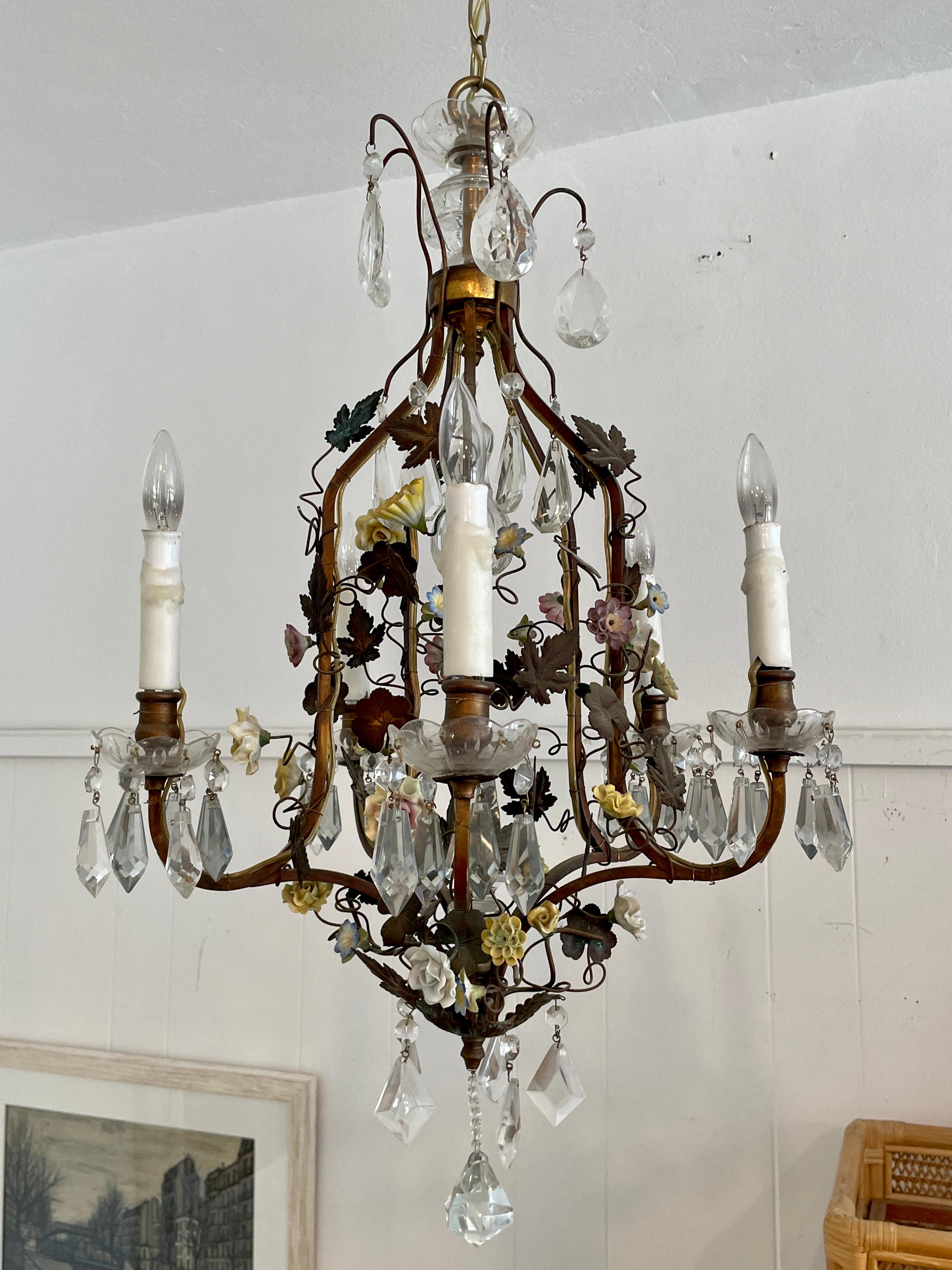 Beautiful French tole chandelier. Amazing porcelain flower details around the piece. Great addition to your chic interiors.