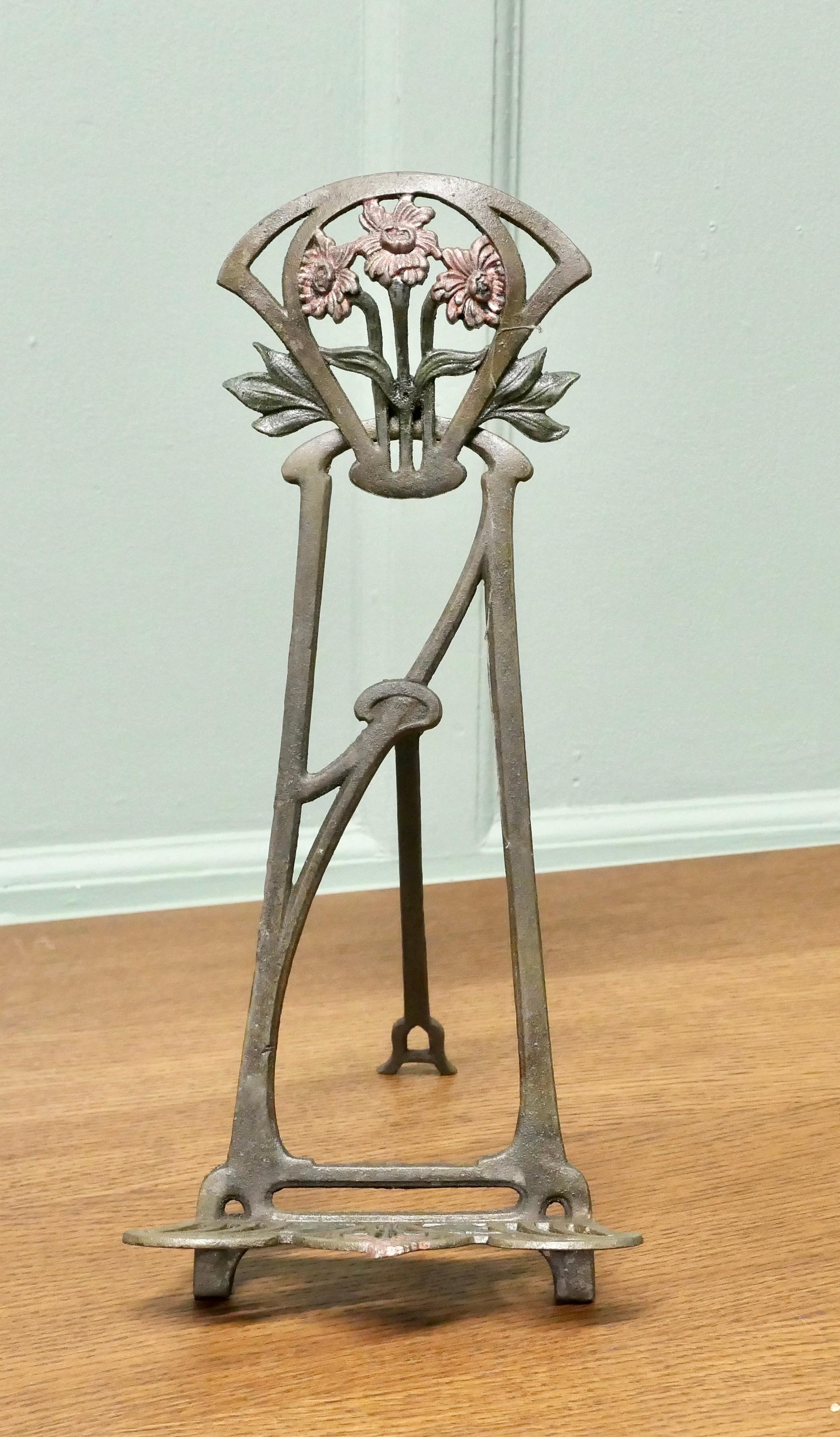 French Tolewear Table Easel or Book Rest 

This is a very attractive piece it is made in iron and has decorative detail mostly on the top and on the rest at the bottom of the stand, this is decorated with flowers and highlighted with verdigris and