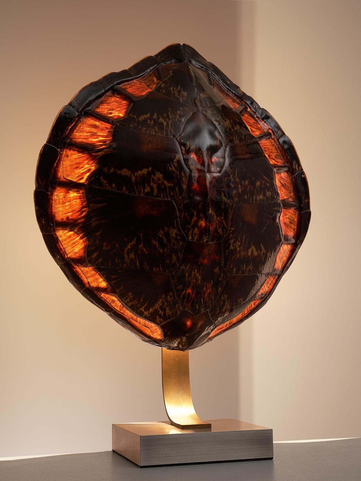 Maria Pergay (attribution), brass, tortoise shell, brushed steel, France, circa 1970. 

This table lamp is attributed to Maria Pergay. The piece is a-typical for French design of the 1970s as the style of the time was very functionalist, objective