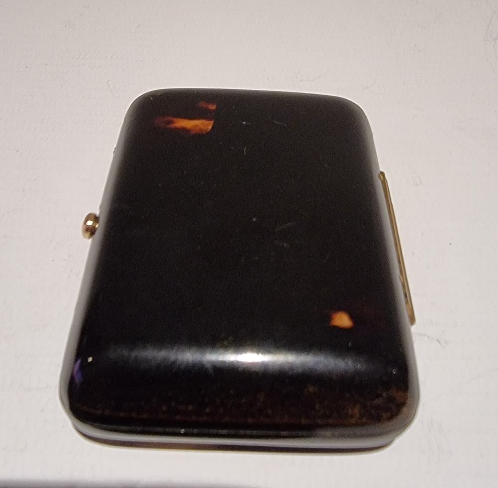 A French Tortoiseshell and gold inlaid purse with red silk inner lining. A very pretty and unusual item, the tortoiseshell in very good condition.