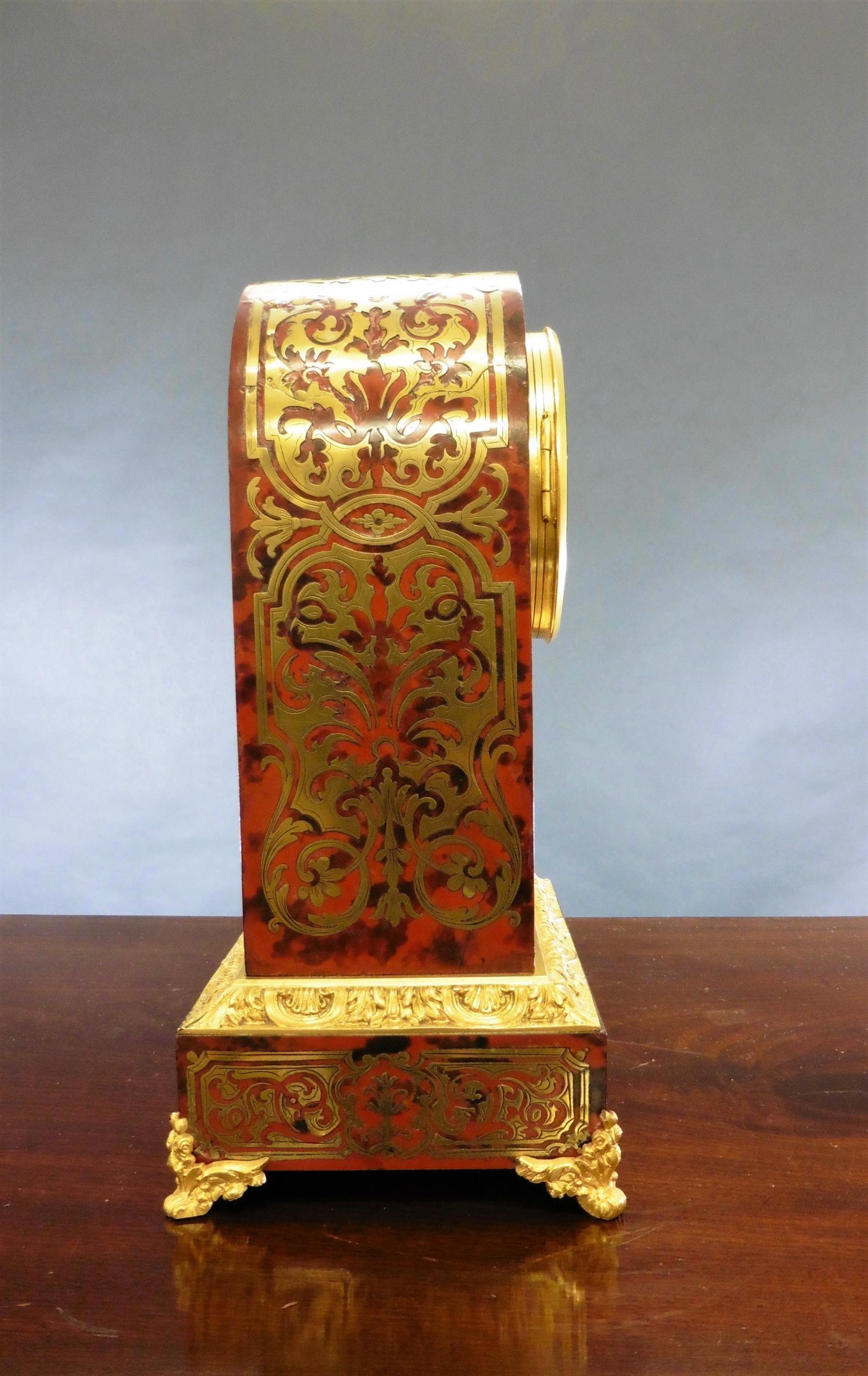 Fine Tortoiseshell Boulle clock in an arch top case, standing on elaborate gilded Ormolu feet with raised base with Acanthus leaf decoration.

two-piece enamel dial with Brocot (visible) escapement, original ‘blued’ steel hands with Roman numerals