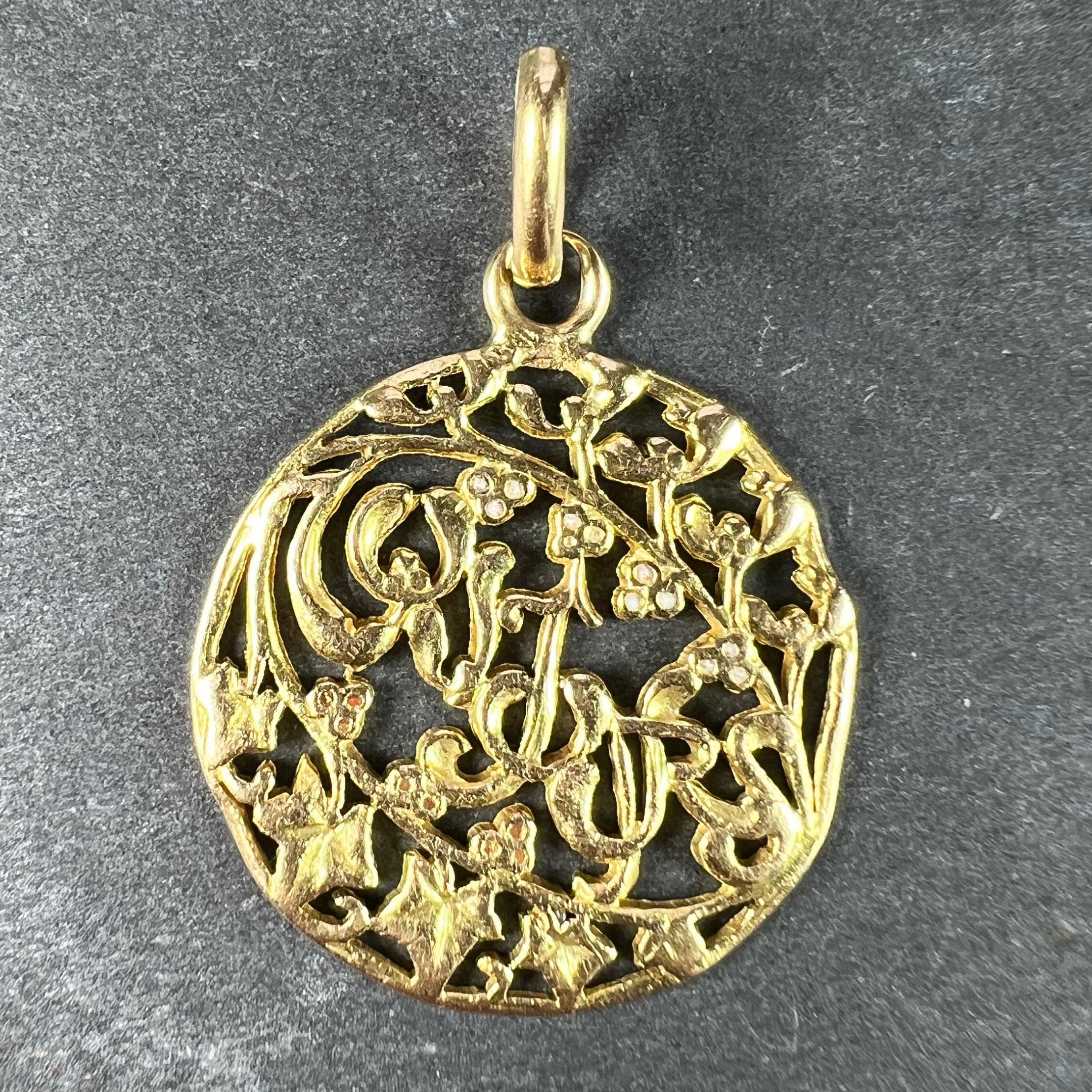 A French 18 karat (18K) yellow gold charm pendant with highlights of red and white enamel, designed as the word TOUJOURS (forever) with entwined letters resembling mistletoe leaves beneath a spray of mistletoe and its white berries, and above a