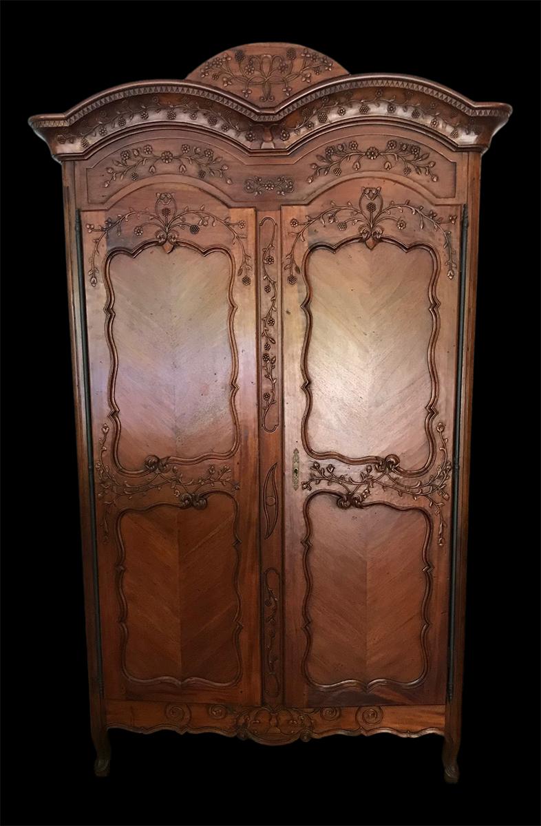 Beautiful hand carved vintage French armoire. Two doors open to reveal 3 shelves. Lots of room for storage. The lock is functioning and the solid brass hardware and hinge are all original. Dainty carved florals adorn the entire front with detail