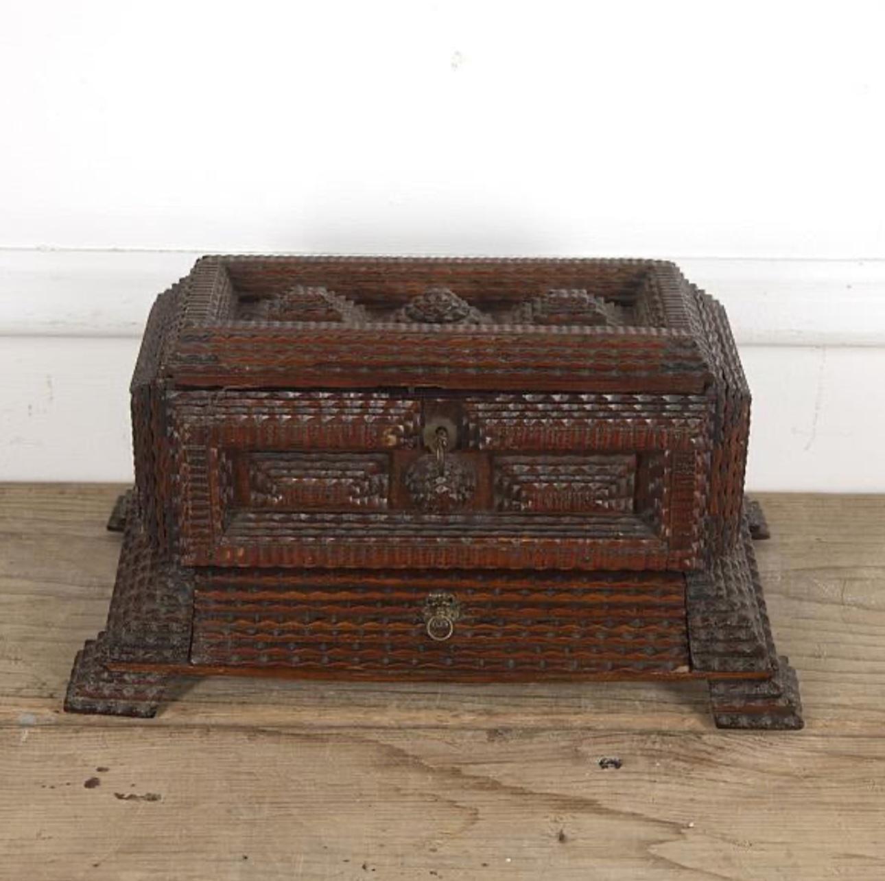 French tramp art box from the early 20th century. Tramp art is a style of folk art popular around the turn of the century that uses wood notch carving and found materials to incredible artistic effect. 

France, circa 1900

Dimensions: 6.5H x