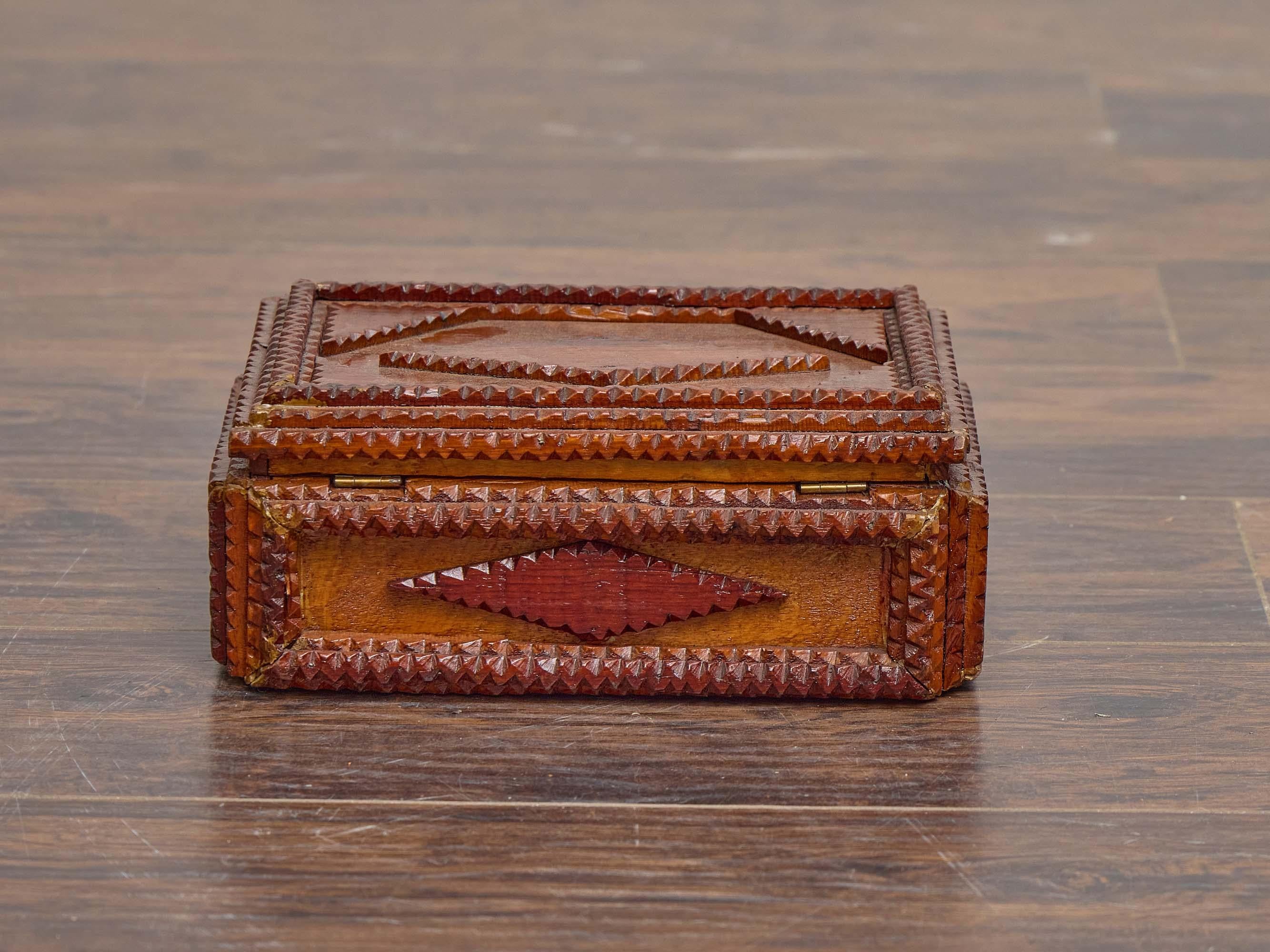 A French Tramp Art wooden box dating to circa 1890, intricately hand-carved with the layered, notched construction characteristic of the style. The rectangular form is richly ornamented with raised diamond motifs on all sides, each built from