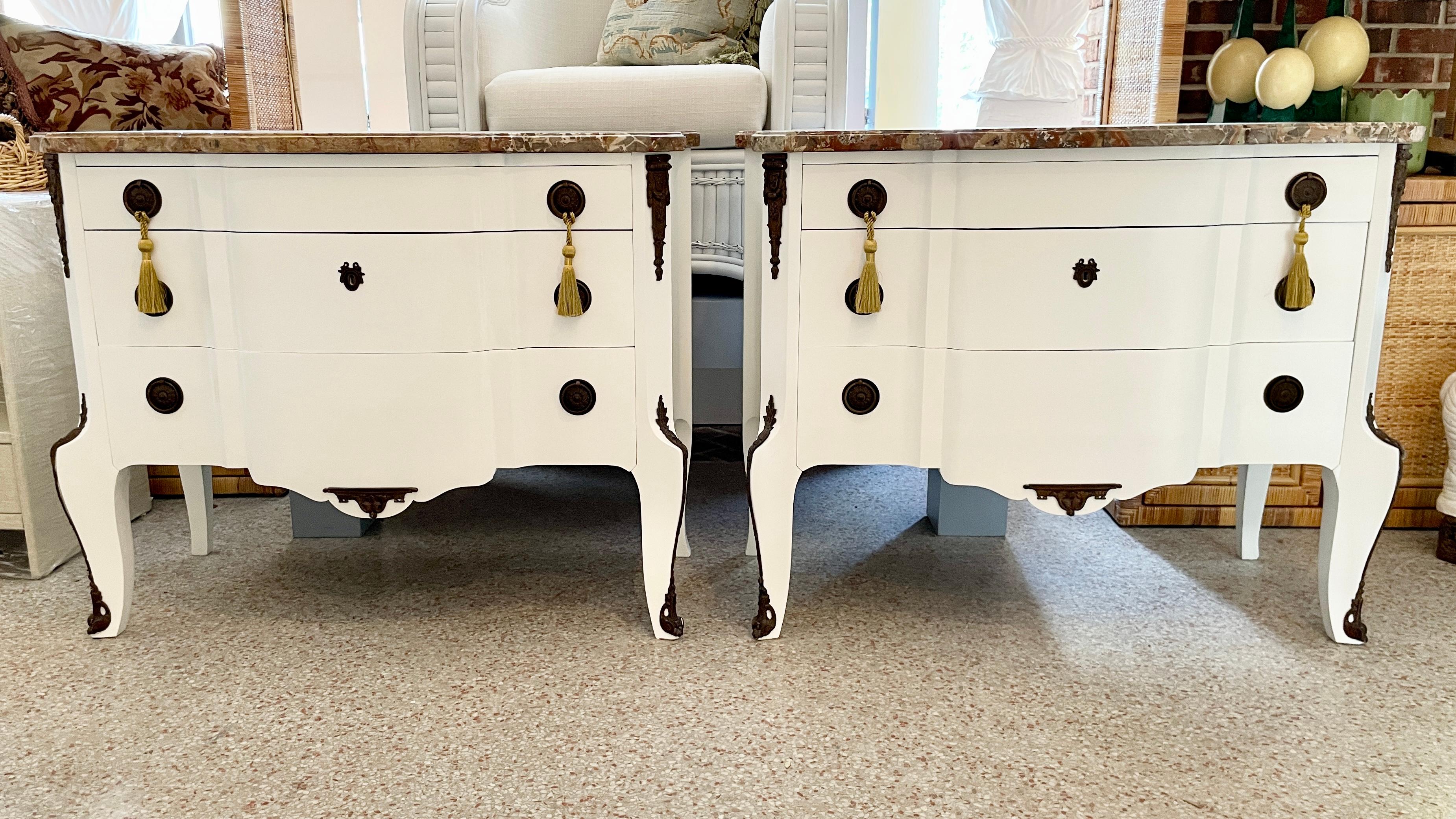Beautiful pair of 3-drawer French Transition commodes freshly lacquered in white with original marble tops and bronze hardware and details. Original tassels included. Great addition to your French inspired interiors and rooms.