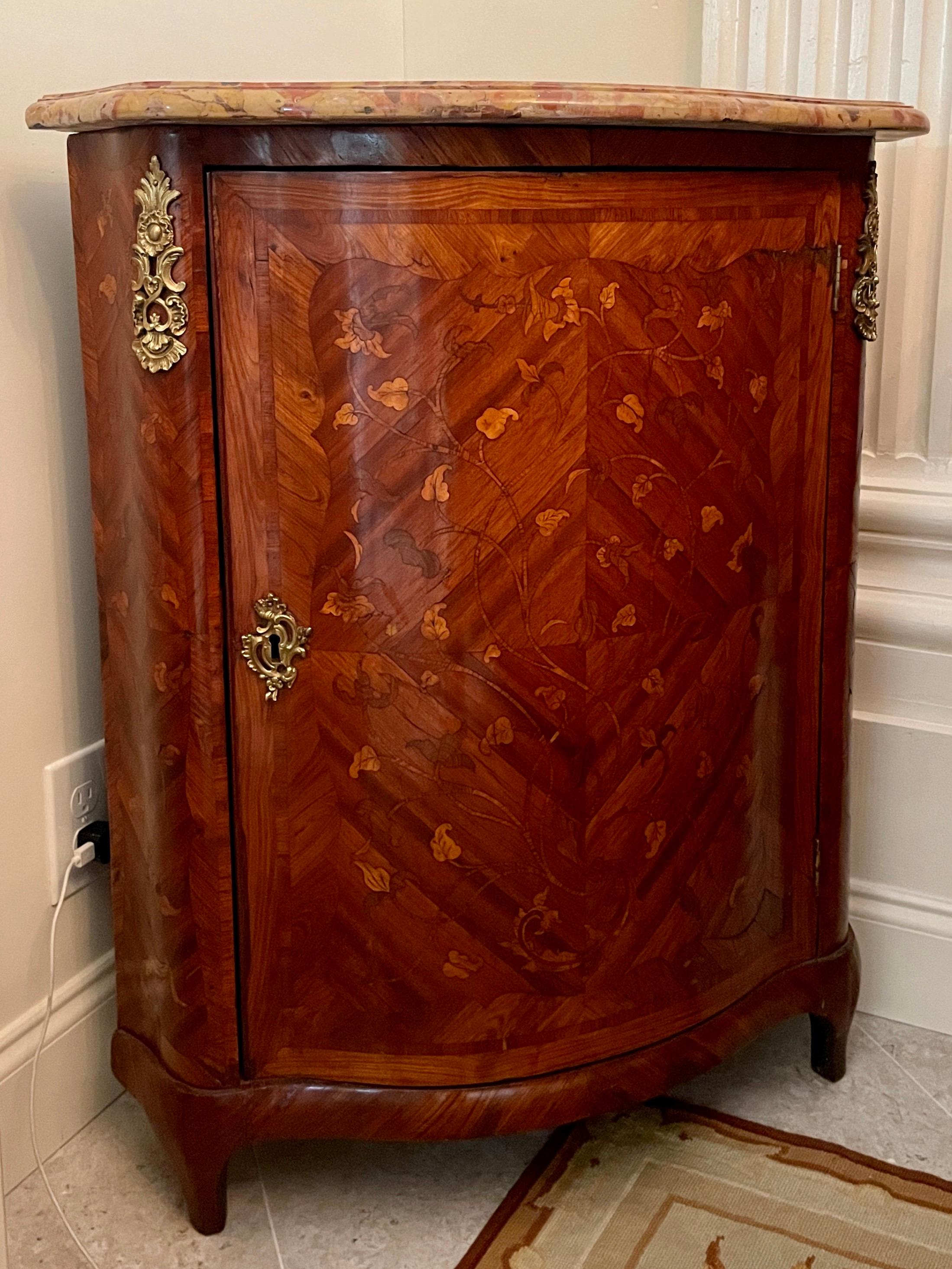 French transition marble top corner cabinet with makers label. Key is not included. Beautiful marquetry work and original marble top.