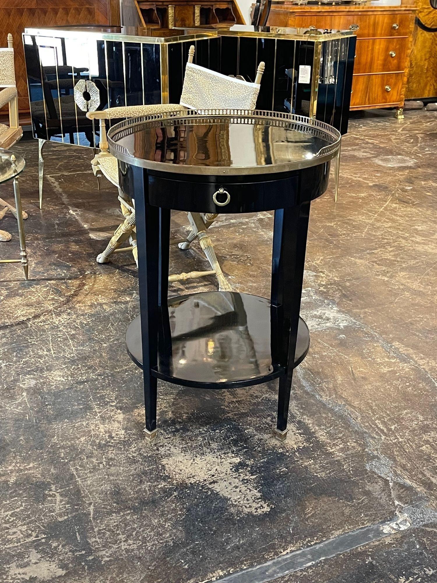 Handsome 19th century French transitional black lacquered side table. The piece also has a lovely black glass top and brass feet and galleries. Creates a very polished look. So pretty!!