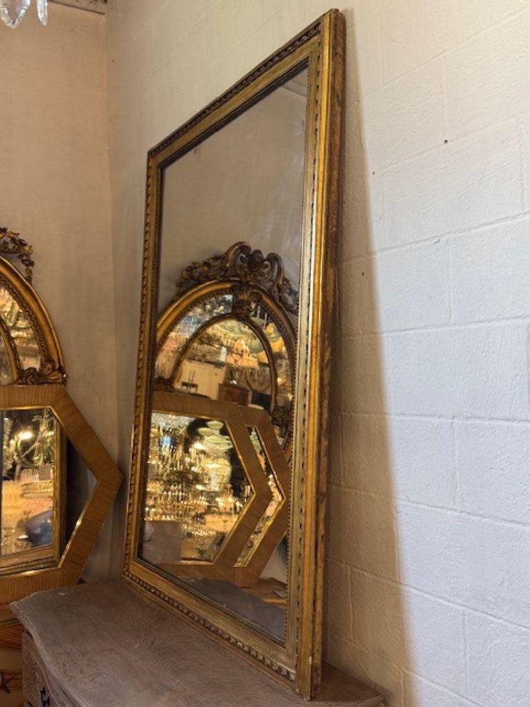 19th Century French transitional carved and gilt wood mirror. You're exploring a piece that bridges ornate Rococo and restrained Neoclassicism—19th-century French transitional carved and giltwood mirrors are prized for their elegant proportions,