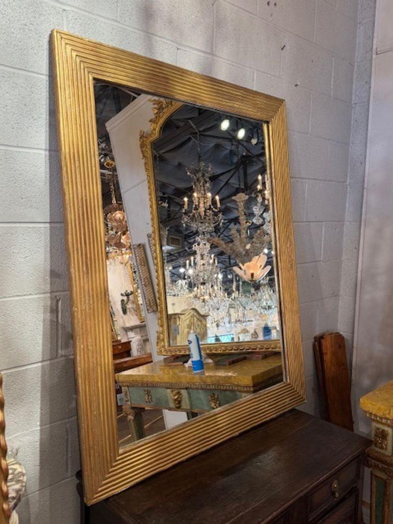 19th century French transitional carved and giltwood mirror. These mirrors are perfect for layering architectural interest into salons, bedrooms, or hallways. Circa 1870. 41w x 51h