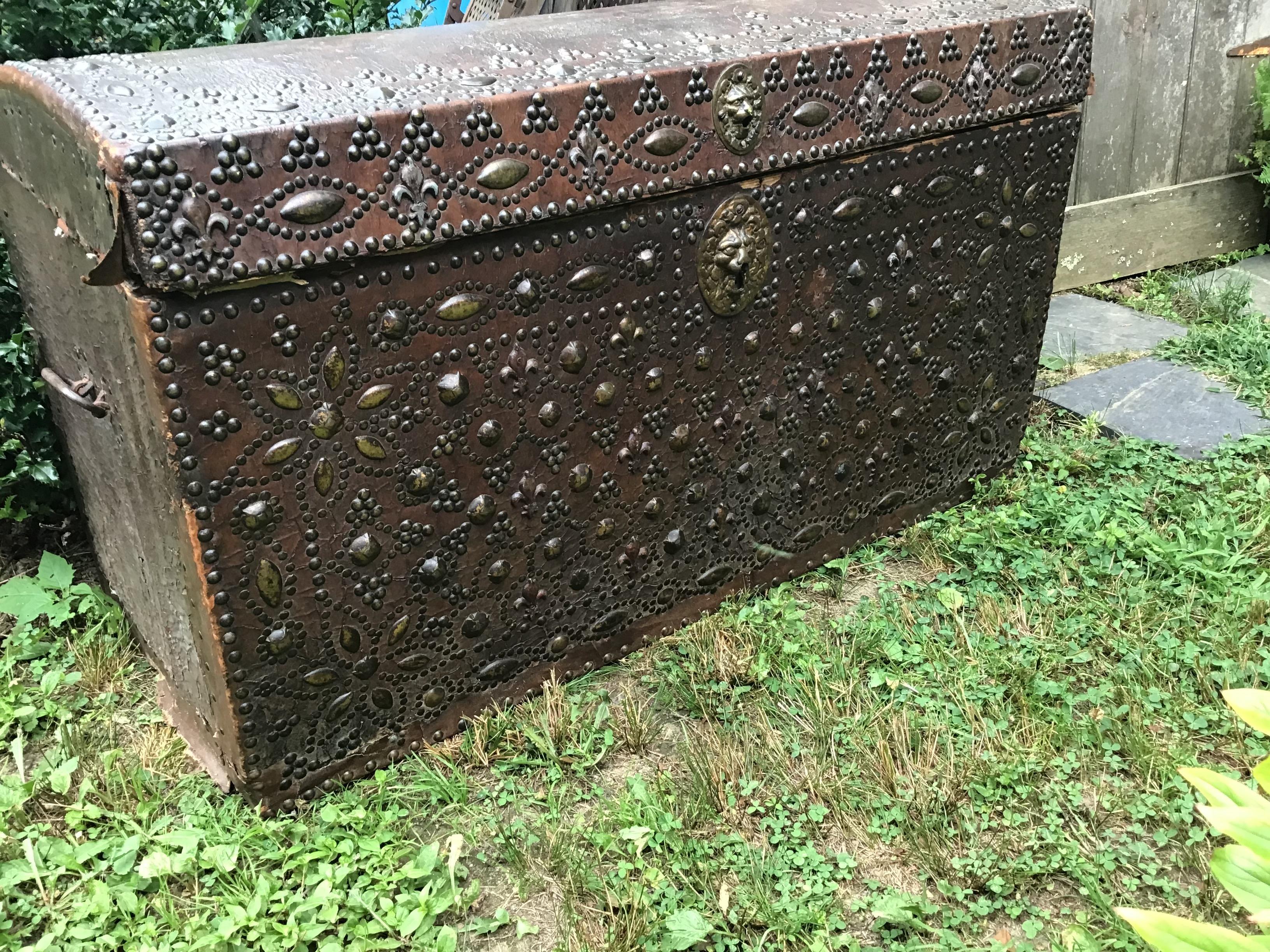 Antique French trunk, traveling trunk, domed top trunk, leather, ornate studded,
Fleur De Lys, 1700's trunk, with lion escutcheon.
   