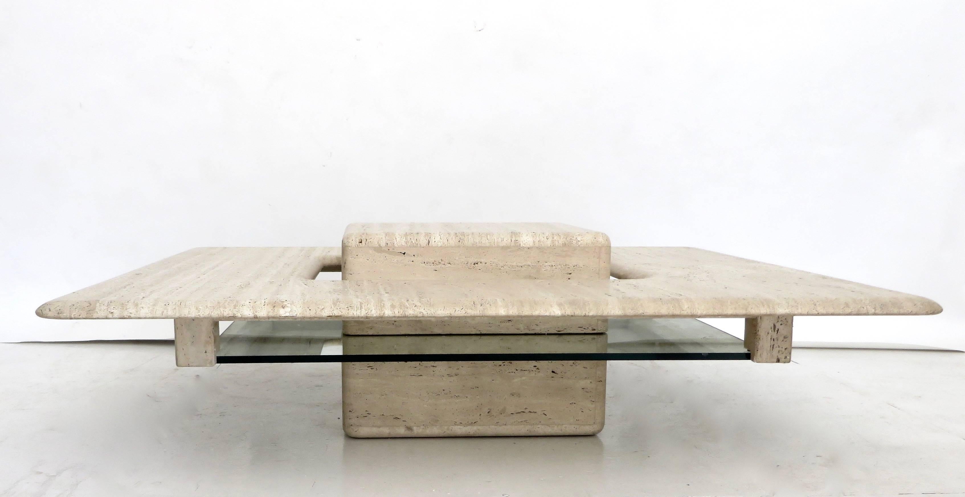 A Minimalist French circa 1970 travertine marble coffee table.
Italian honed matte and natural travertine marble low square coffee table with a floating cube in the centre that is elevated by a piece of glass that is semi noticeable. The cube then