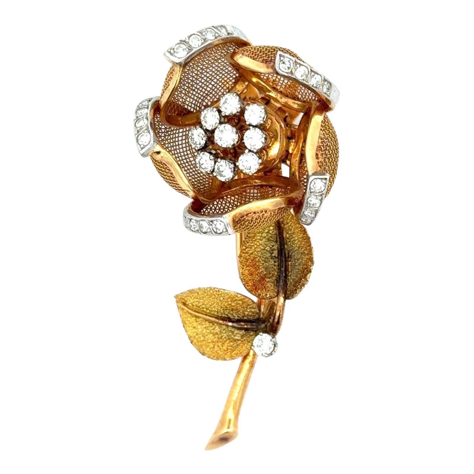 Beautiful French Tremblant floral brooch handcrafted in 18 karat yellow gold. The petals move and are set with round brilliant cut diamonds weighing approximately .85 carat total weight and graded F-G color and VS2-SI1 clarity. The pin measures 2.00