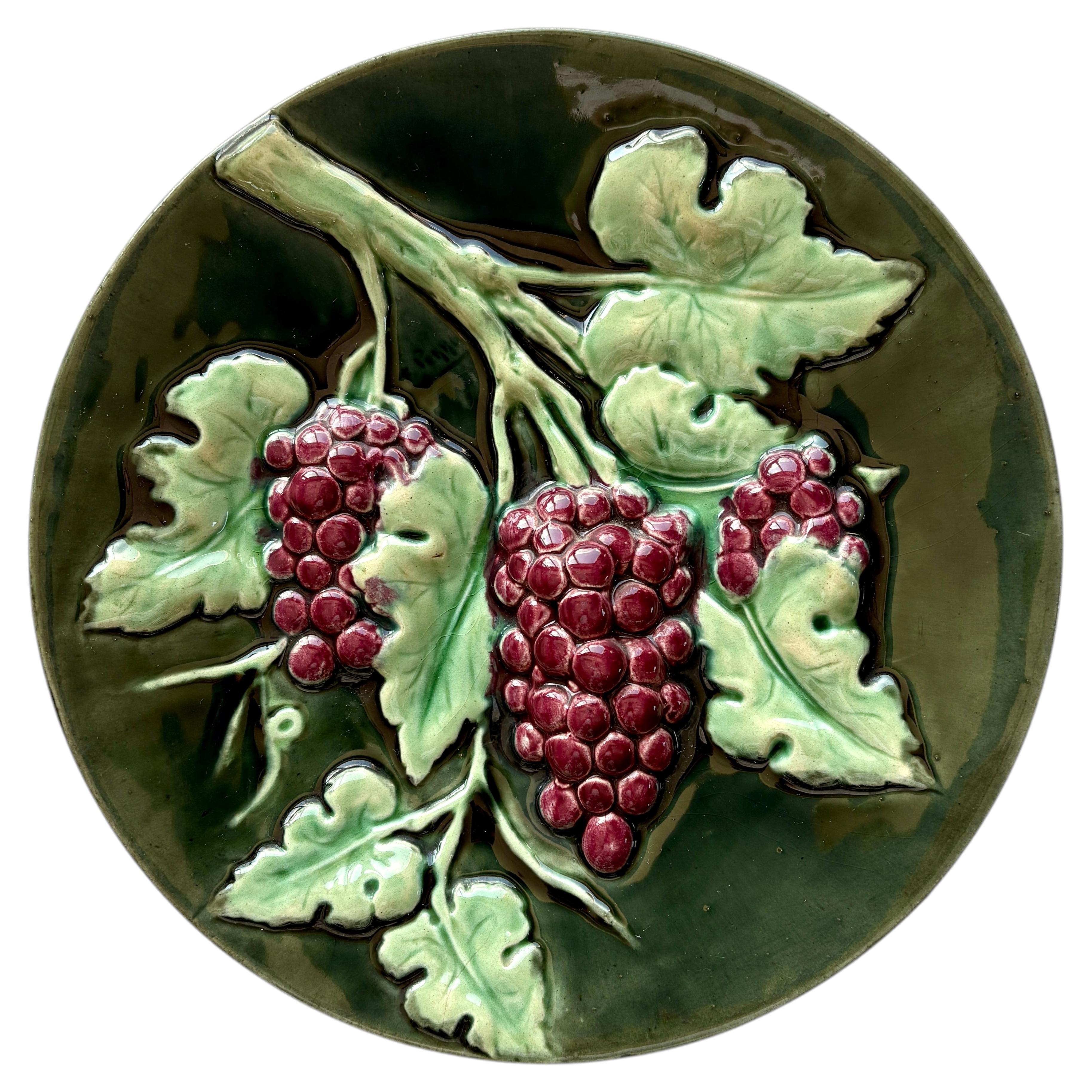 French trompe l'œil majolica wall plaque with grapes, signed F. Perrot, c. 1890