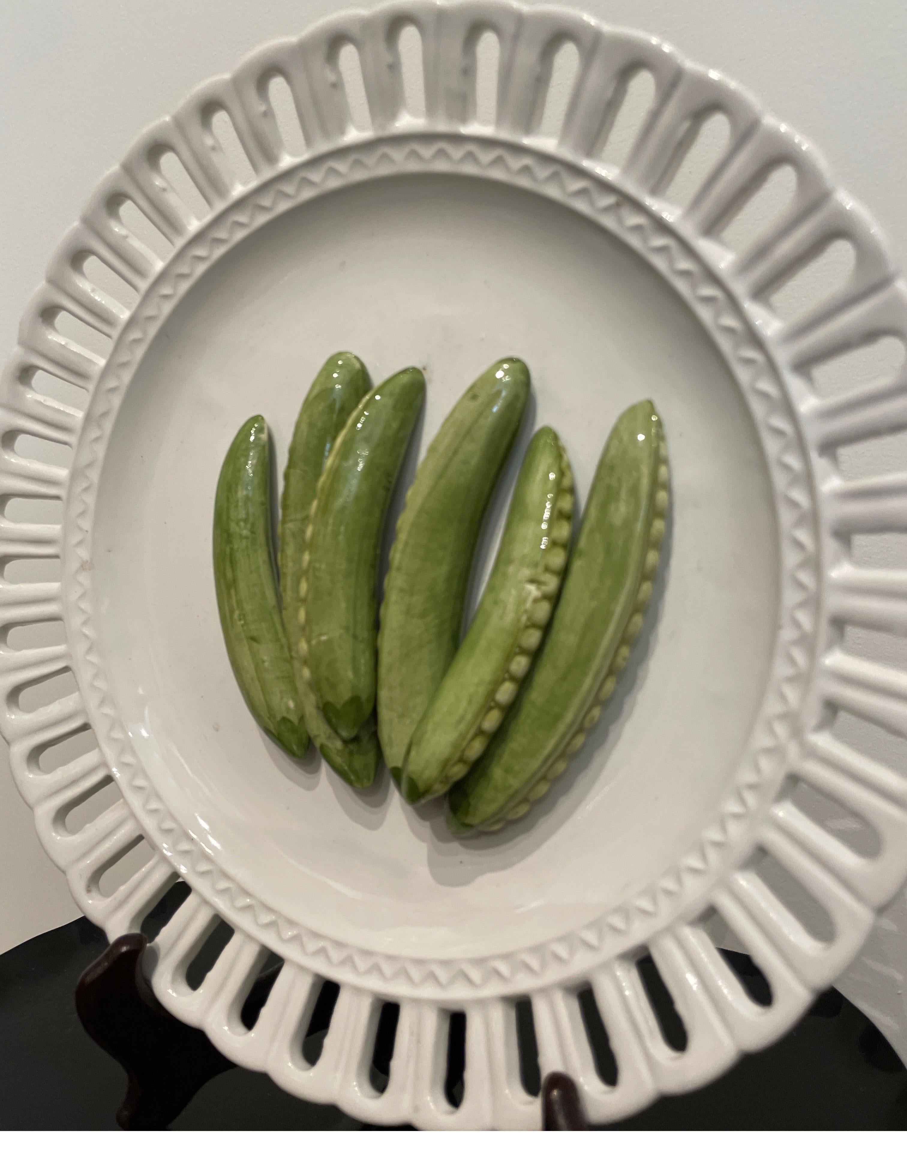 Very sweet single Trompe L'oeil white pierced border plate with several pea pods in the center. This plate would be a great start to a collection or an addition to an existing one. A lovely piece.
