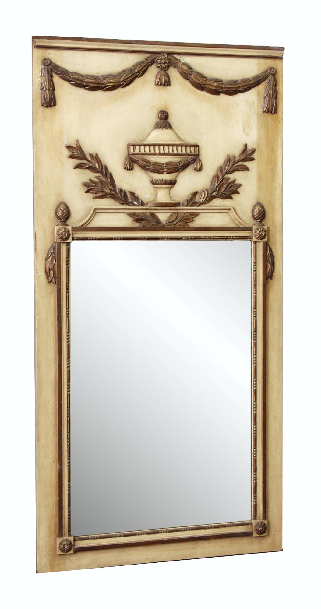 Circa 1900, gilded French trumeau over mantel mirror. The hand carved wood frame has gold gilded tassels lining the top edge and and a gold gilded leaf and urn design directly above the mirror. The background is painted an antique creme color. This