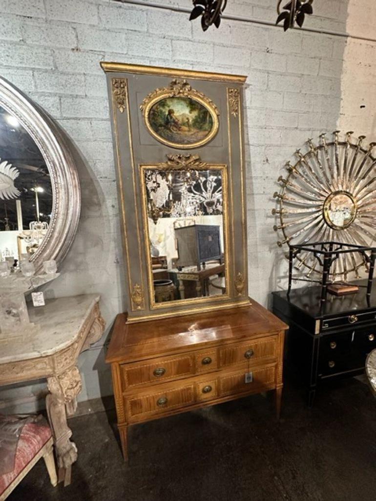 19th century French carved and parcel gilt trumeau mirror with oil on panel of boy and dog. Circa 1850. A fine addition to any home!