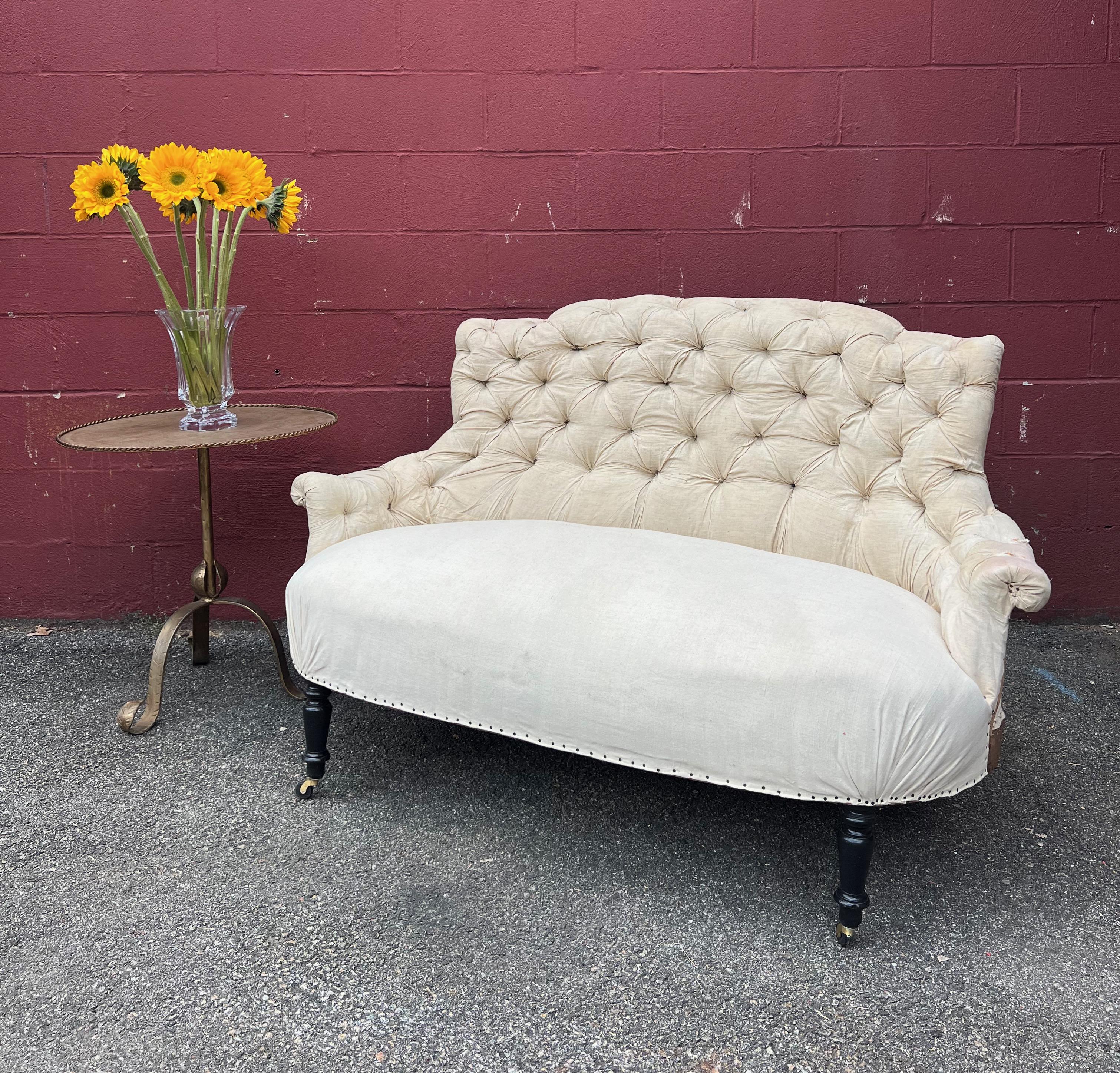 French Tufted Napoleon III Settee A wonderfully proportioned small French settee from the Napoleon III period having a gracious curved back with exquisite tufting. The settee has been stripped down to the original muslin leaving it ready for
