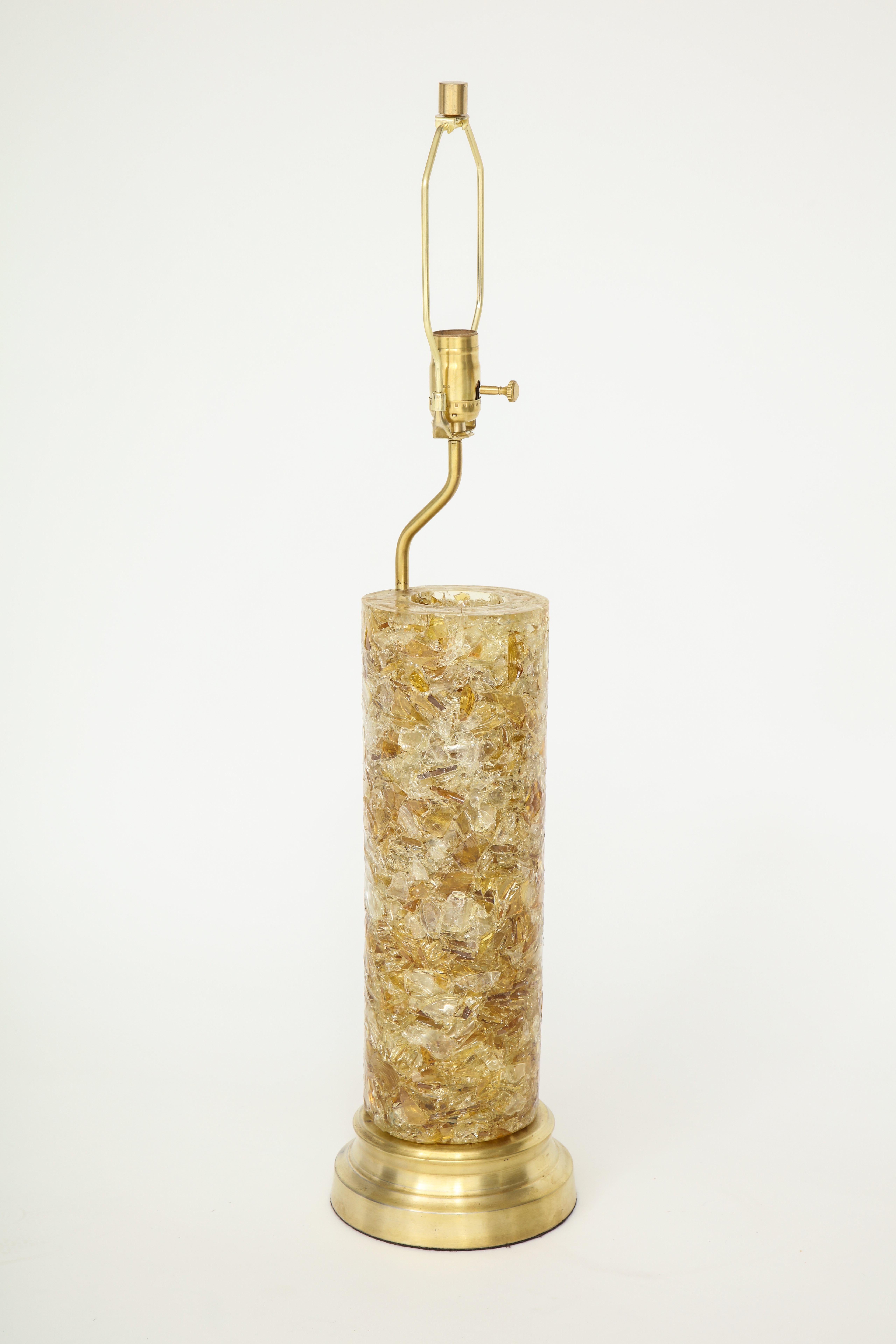 French Midcentury column lamp with internal illuminating option. Lamp column is made from crushed glass fragments suspended in resin, resting on satin brass base. Rewired for use in the USA. 100 W max bulb. Base and glass body measures 17 inches.