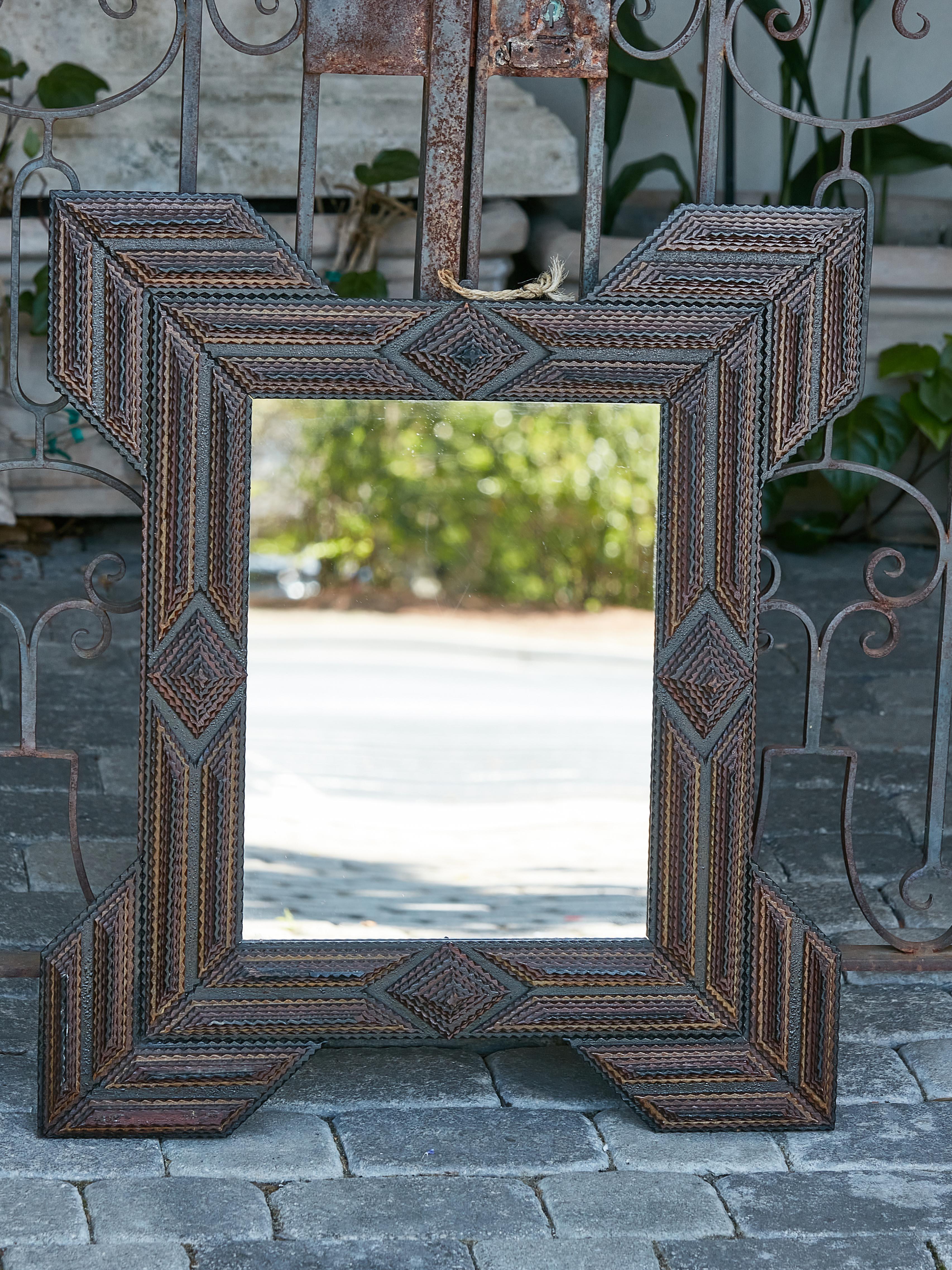 A French Turn of the Century Tramp Art period hand-carved mirror with large protruding corners. Evoke the essence of French craftsmanship with this resplendent French Turn of the Century Tramp Art Mirror, a virtuoso exhibit of meticulous