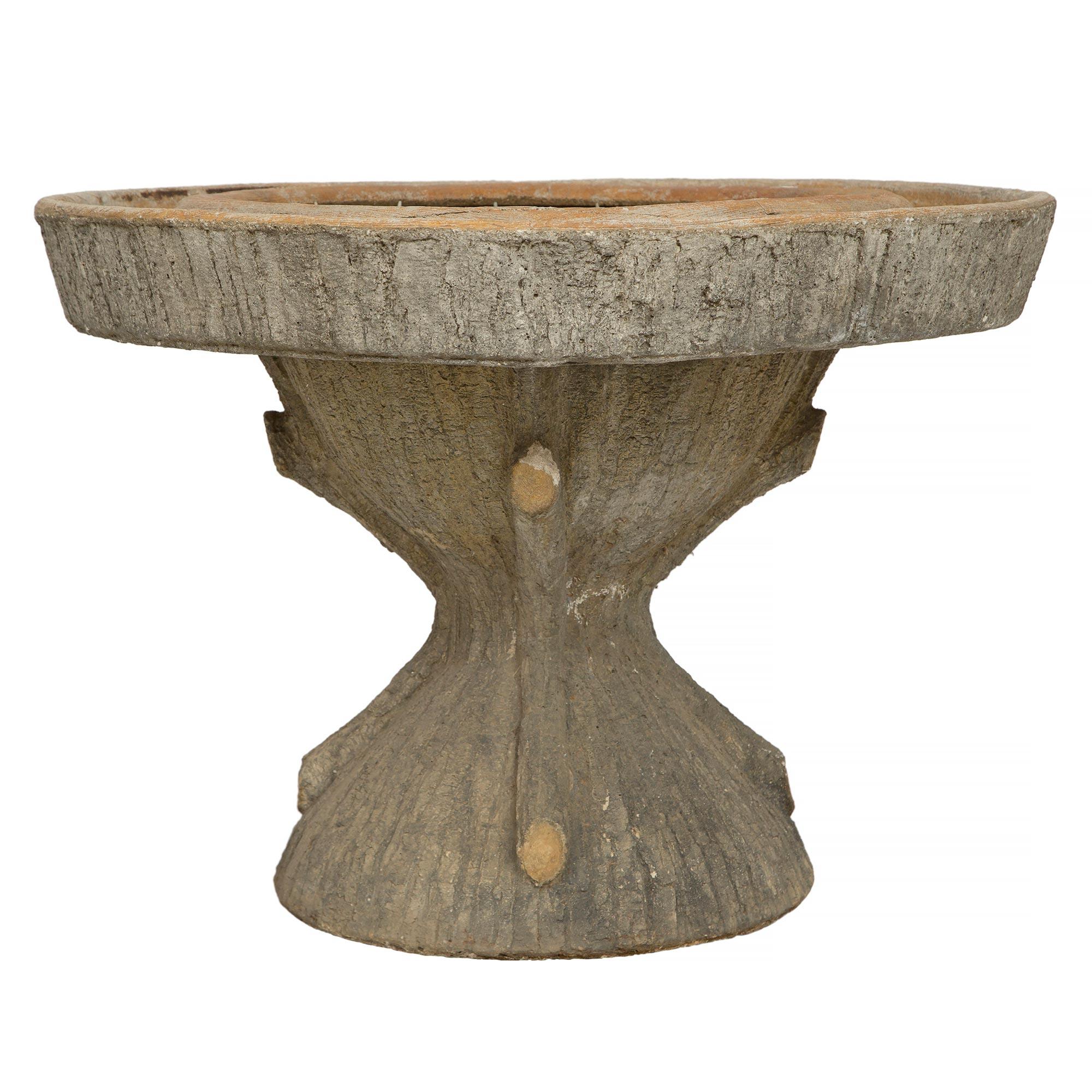 Una bellissima fioriera francese di inizio secolo in Faux Bois. Questa meravigliosa e unica fioriera è sollevata da una base in Faux Bois molto decorativa con affascinanti nodi che imitano un tronco d'albero. Sopra c'è una fioriera circolare che si