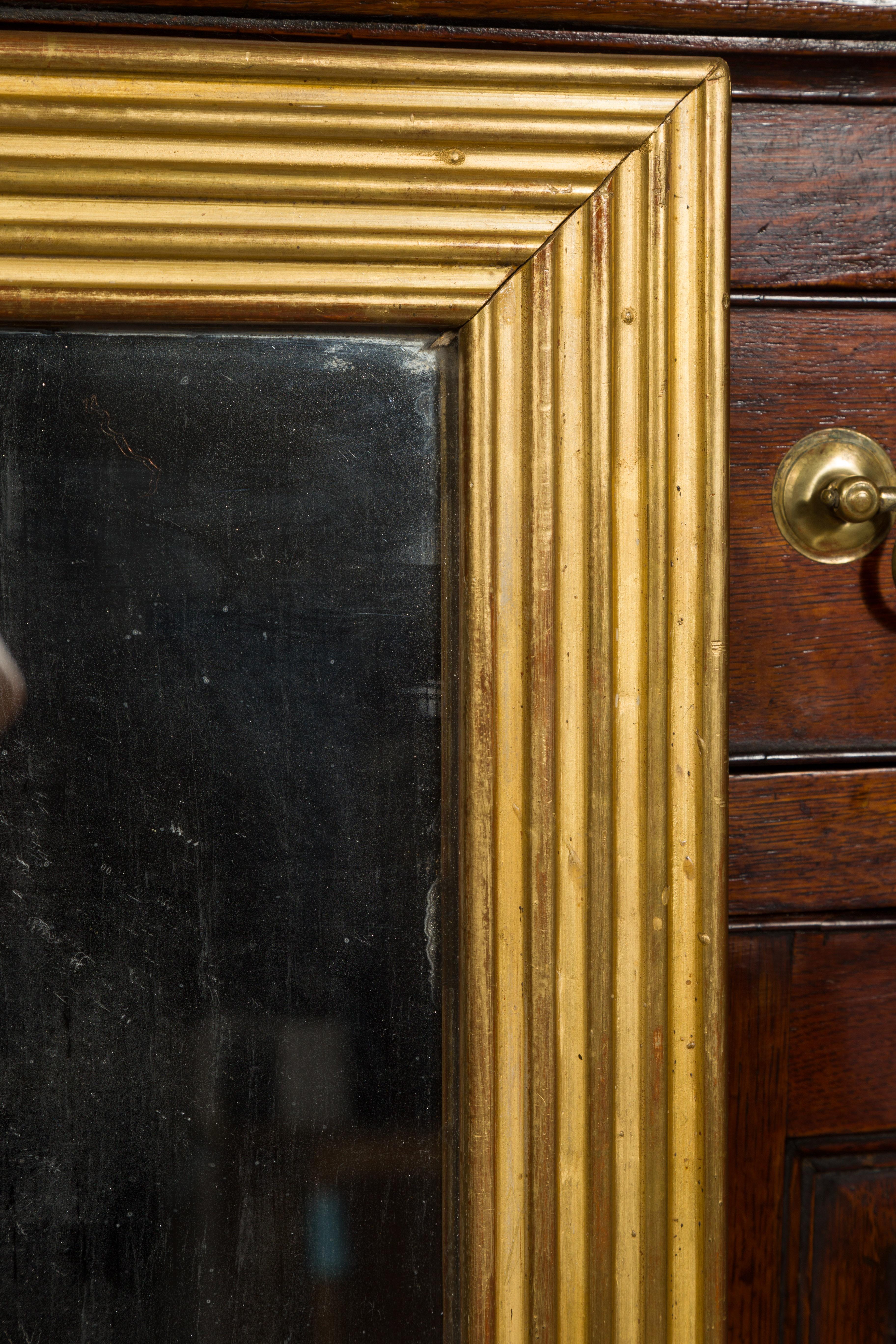 French Turn of the Century Giltwood Mirror with Reeded Frame and Red Undertone 6