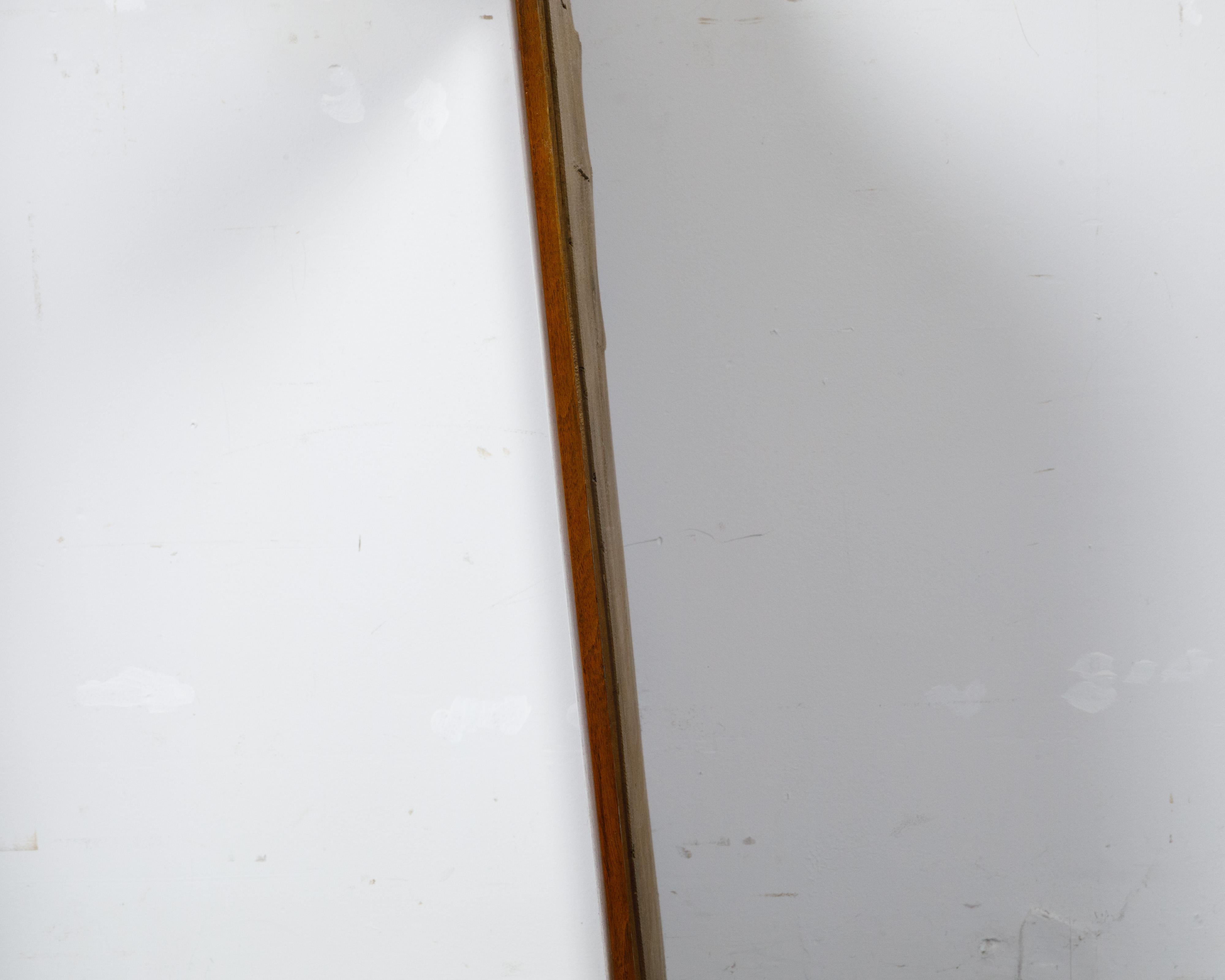 A French Turn of the Century walnut rectangular mirror from circa 1900. Born in France around the turn of the century circa 1900, this exquisite walnut mirror embodies the refined elegance and timeless craftsmanship of the era. The rectangular