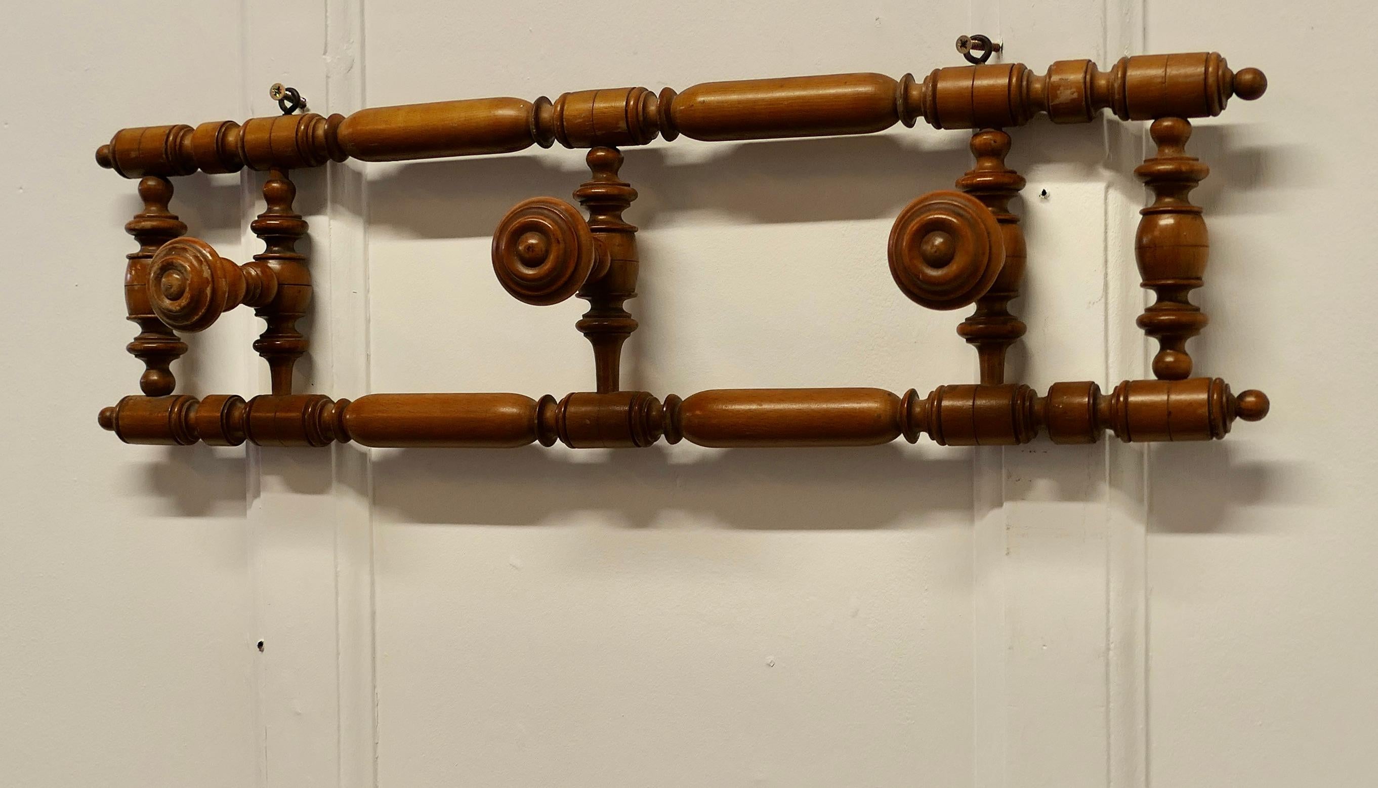 French Turned Beech Hat and Coat Rack

This is a pretty piece it is a wall hanging piece, it has turned round hooks for coats or hats it would make a good hall piece where space is limited as the hooks can be folded flat against the wall
This a