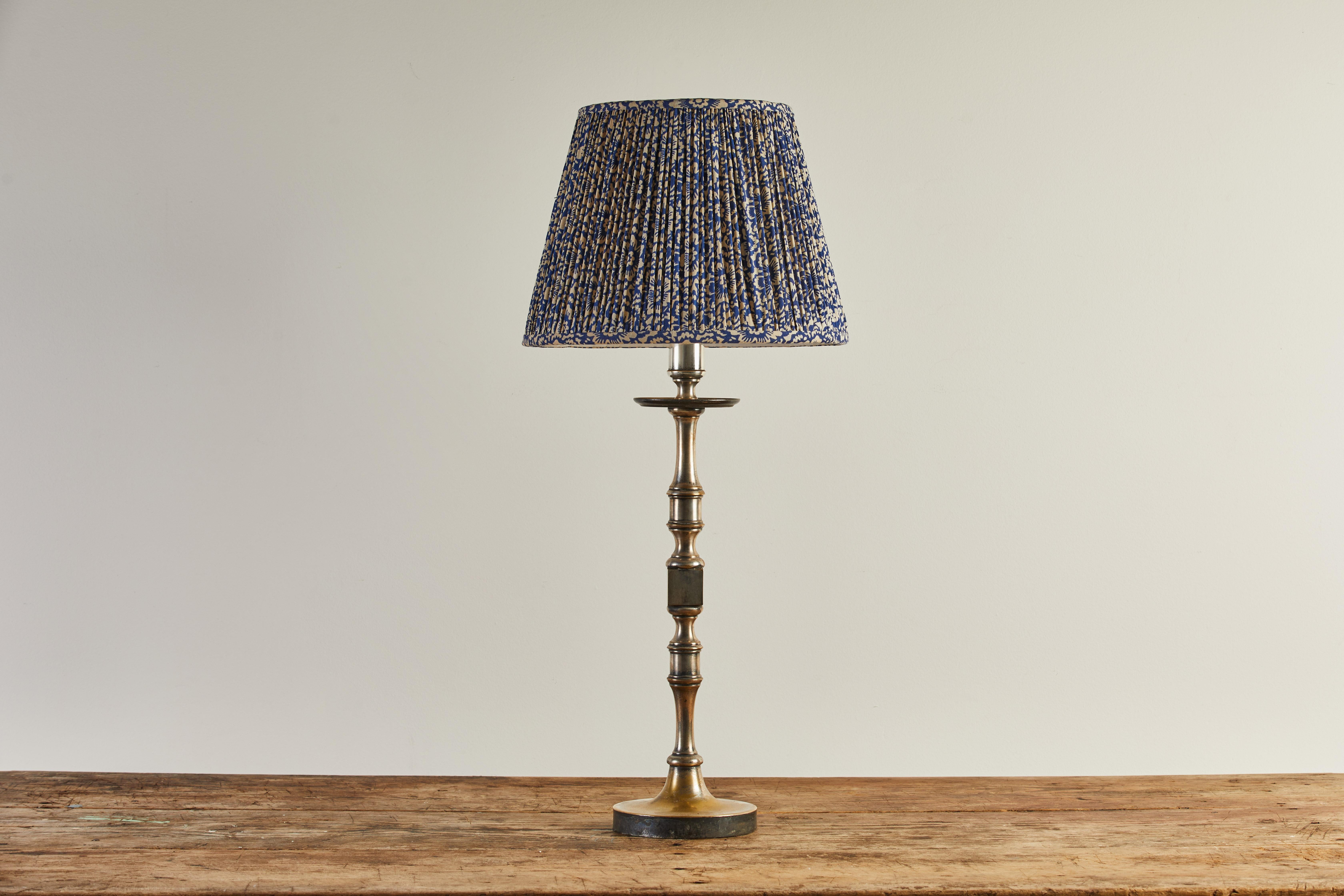 French turned silver table lamp with blue and white shirred floral lampshade. Please note, there is some patina and lustre to the silver finish.