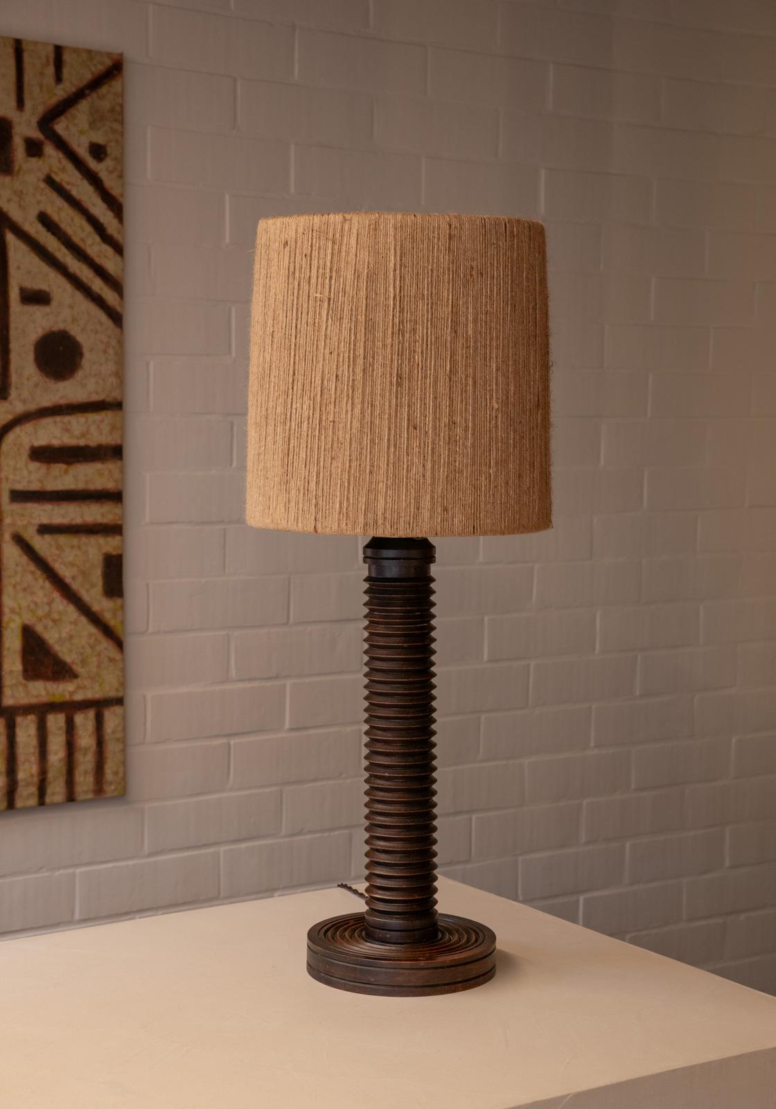 This is a beautiful French antique table lamp from the 40s-50s. To modernize the lamp while preserving its vintage charm, we have chosen a new wicker lampshade that enhances the warm tones of the patinated wood, creating a delightful blend of